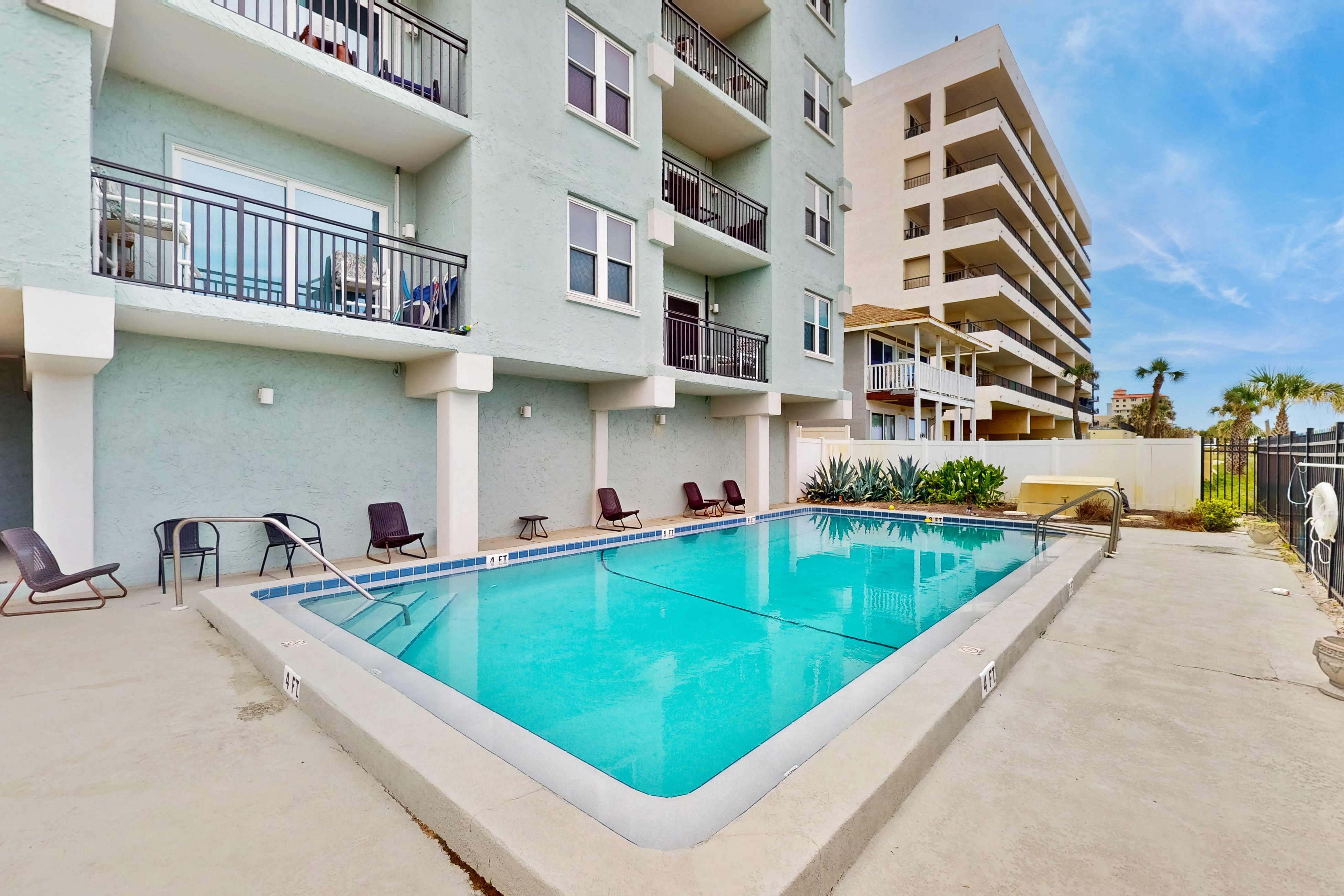 Modern oceanfront condo with outdoor pool, balcony, & washer/dryer