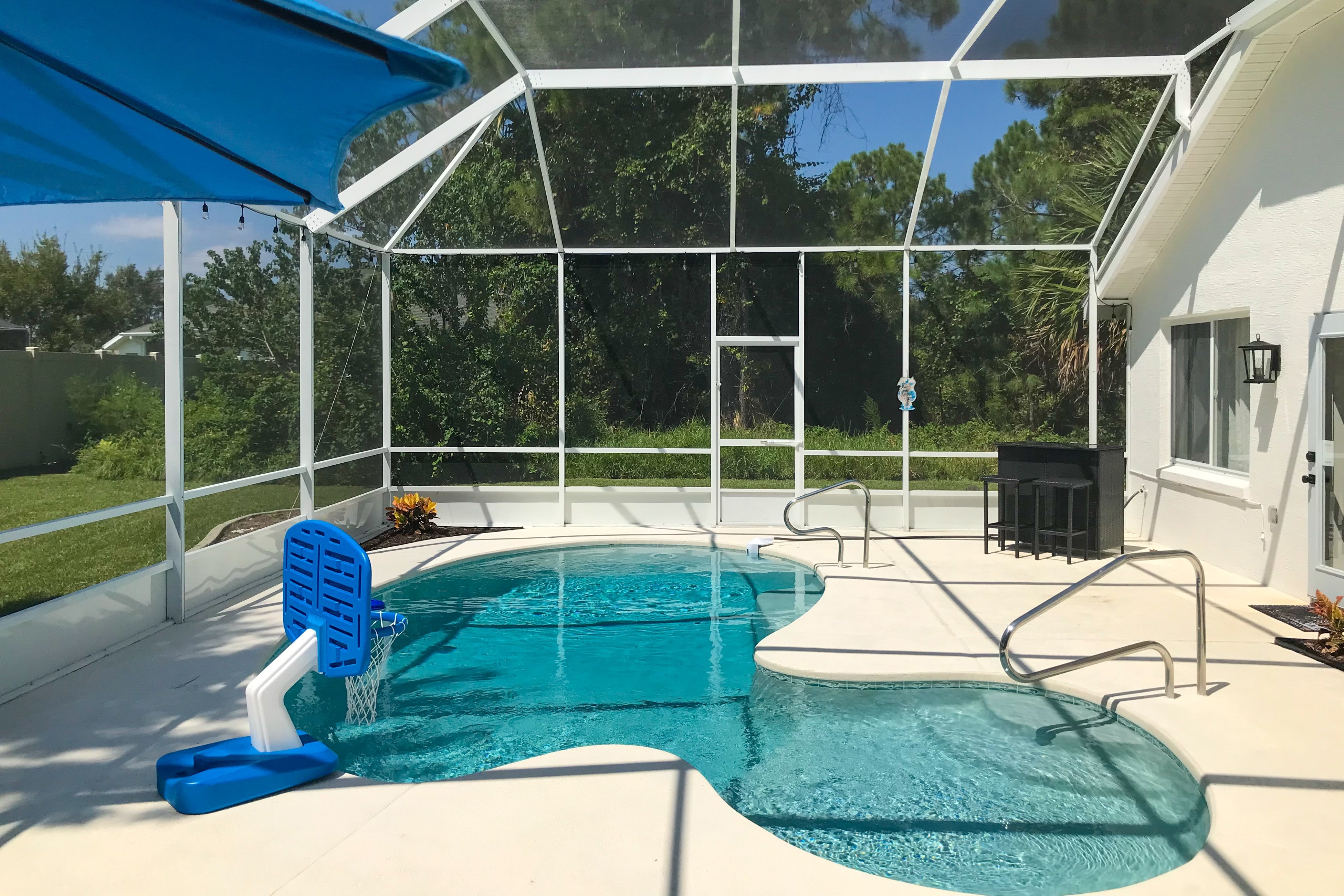 The Barefoot Bungalow | House in Palm Coast with an enclosed pool & grill