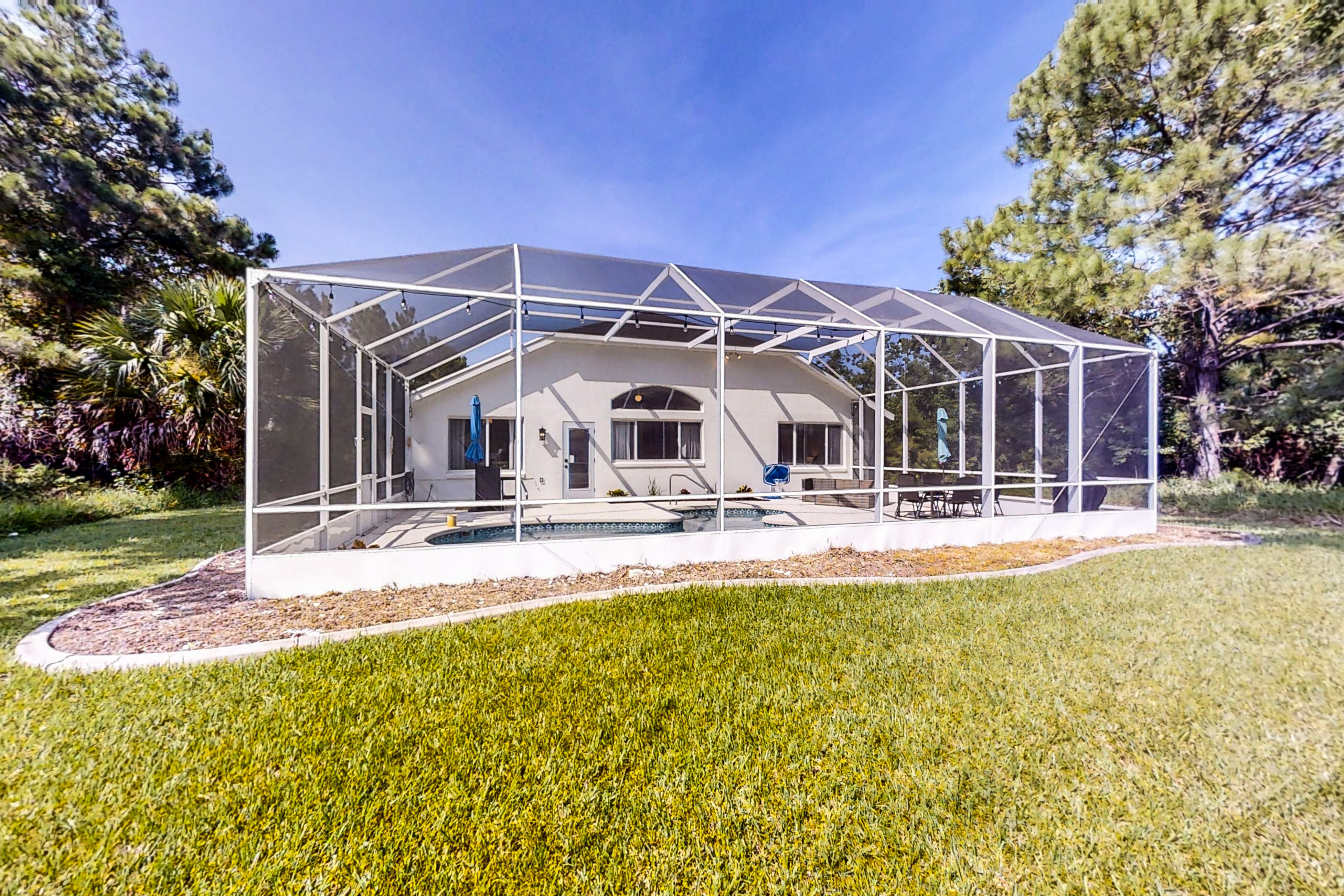 The Barefoot Bungalow | House in Palm Coast with an enclosed pool & grill