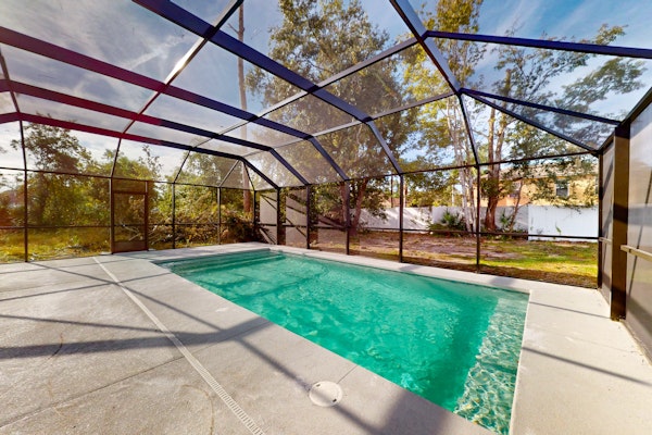 Spacious home with enclosed pool, open layout, washer/dryer, internet, & AC