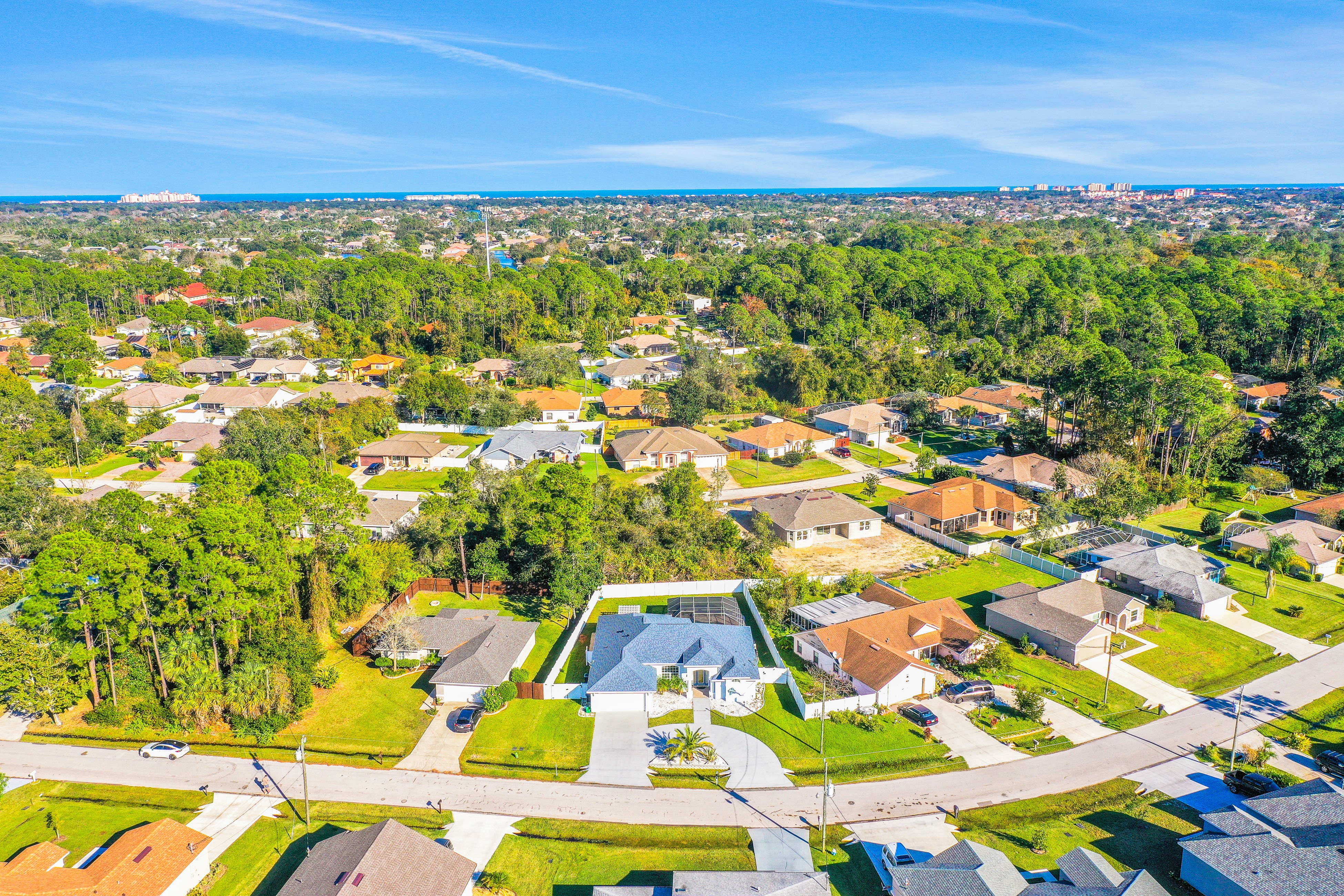 Contemporary coastal escape with heated pool, fenced yard, & outdoor dining