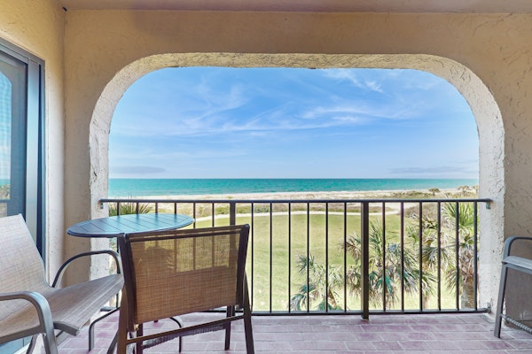 Oceanfront condo with panoramic views, shared pool, and private washer & dryer