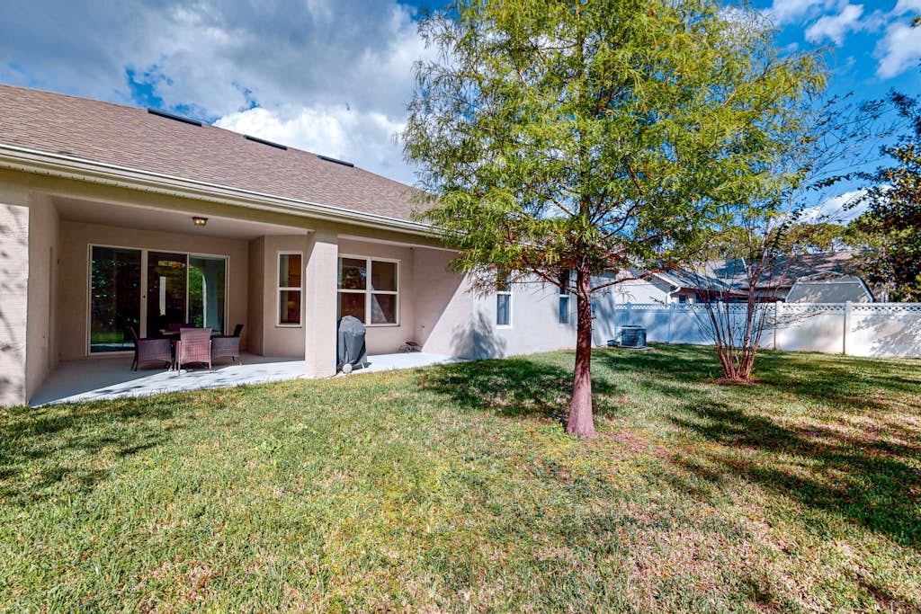 Dog-friendly home with Tesla EV charger, yard, patio, grill, AC, & W/D