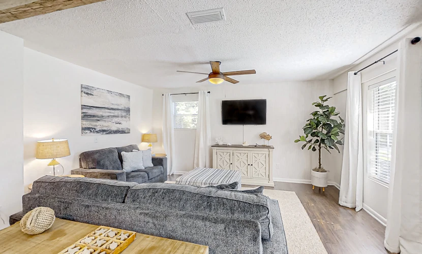 Dog-friendly home with fenced yard, patio, grill, & park across the street