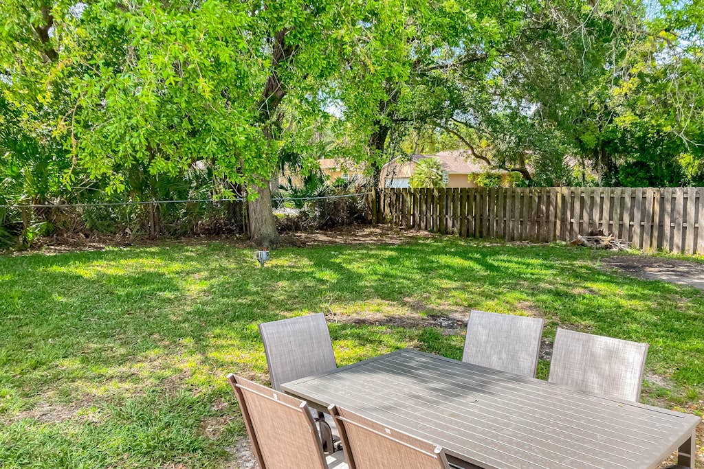 Dog-friendly home with fenced yard, patio, grill, & park across the street