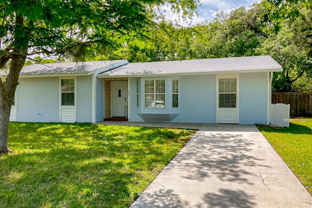 Dog-friendly home with fenced yard, patio, grill, & park across the street