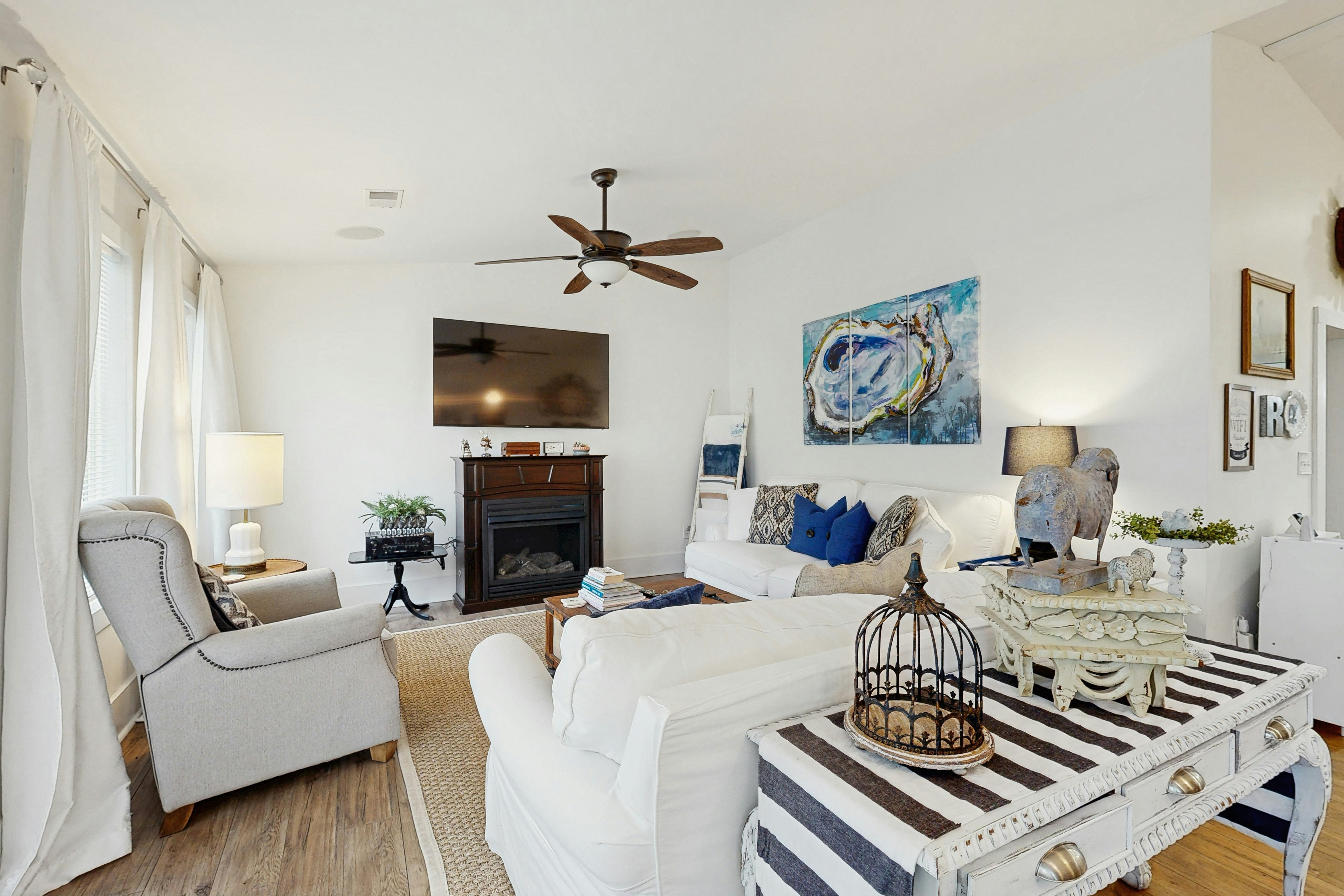 Breezy, renovated home with fenced yard, front porch & lovely living spaces