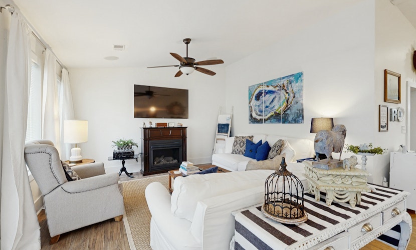 Breezy, renovated home with fenced yard, front porch & lovely living spaces