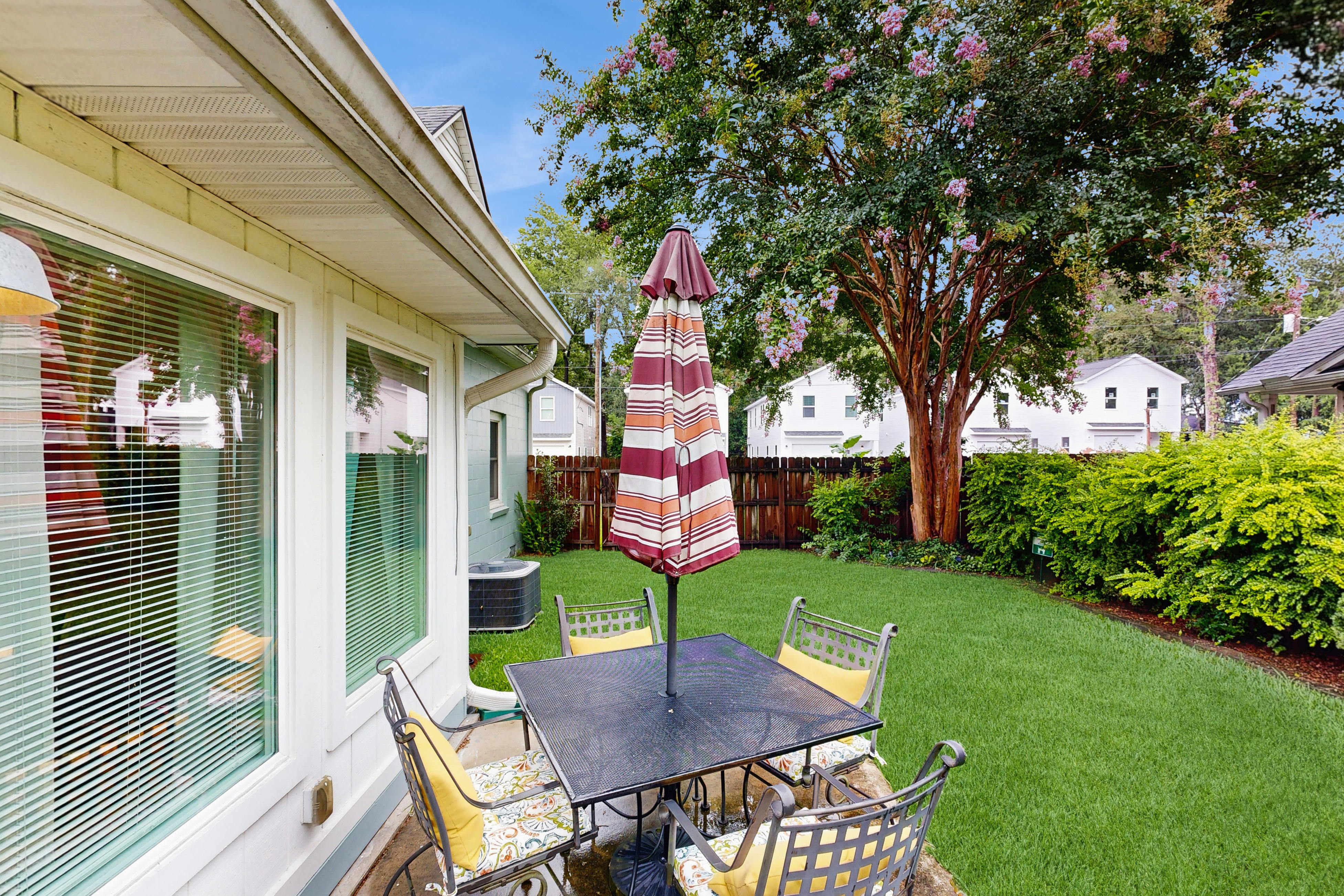 Breezy, renovated home with fenced yard, front porch & lovely living spaces