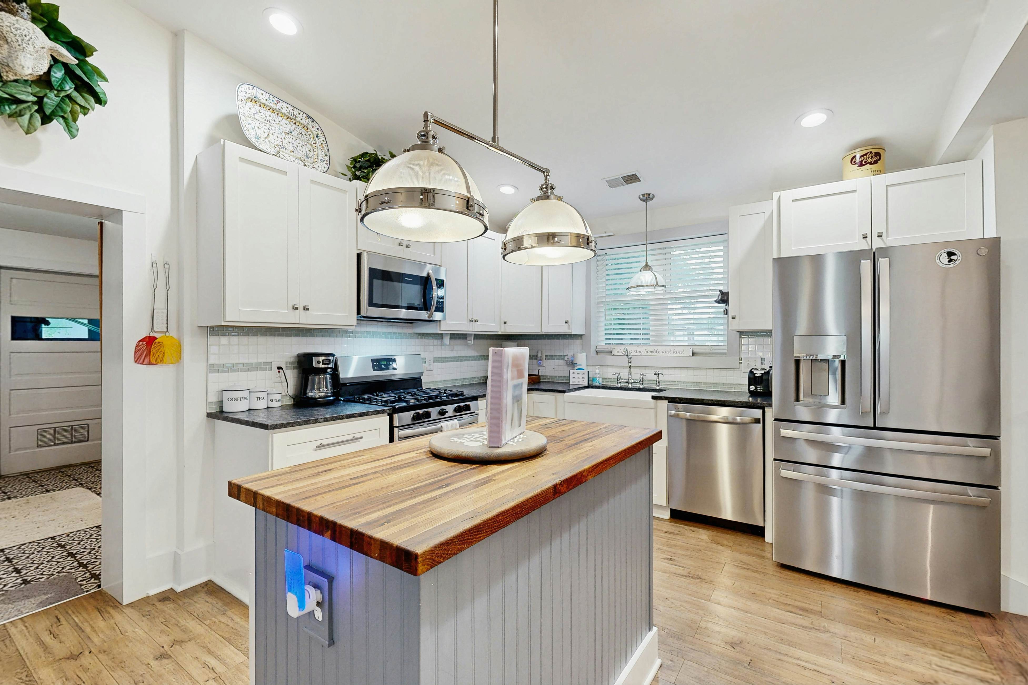 Breezy, renovated home with fenced yard, front porch & lovely living spaces