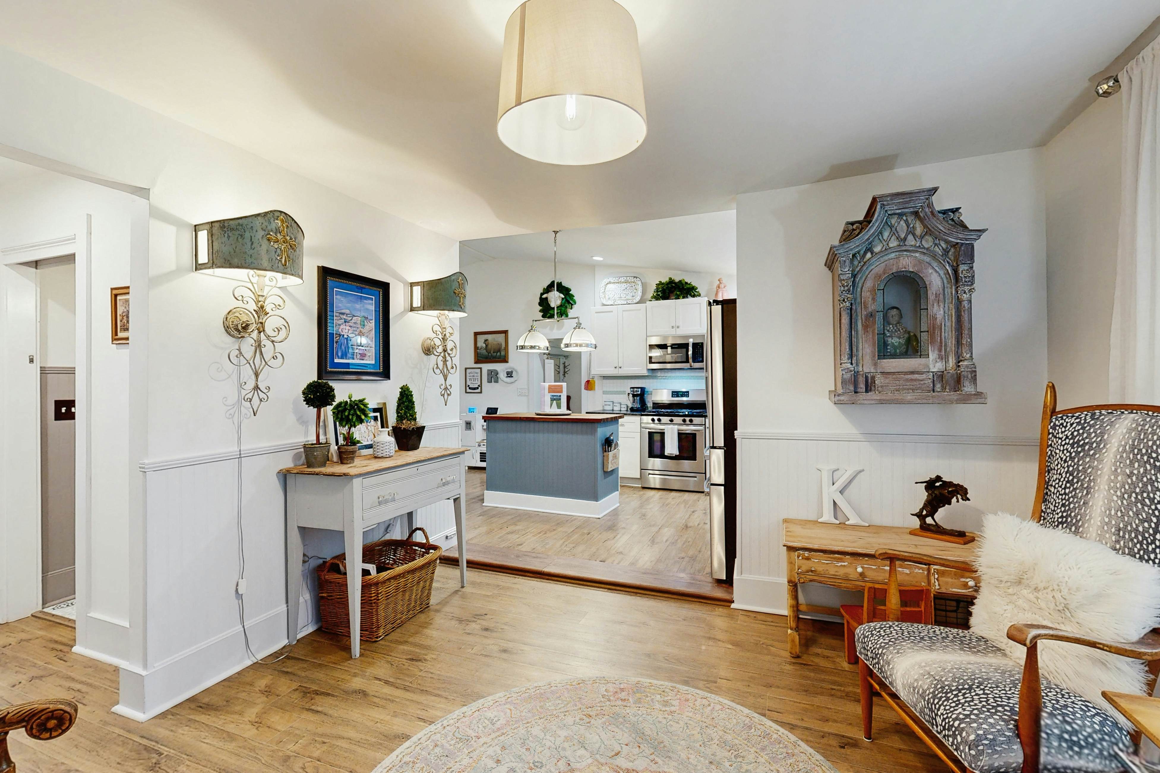 Breezy, renovated home with fenced yard, front porch & lovely living spaces