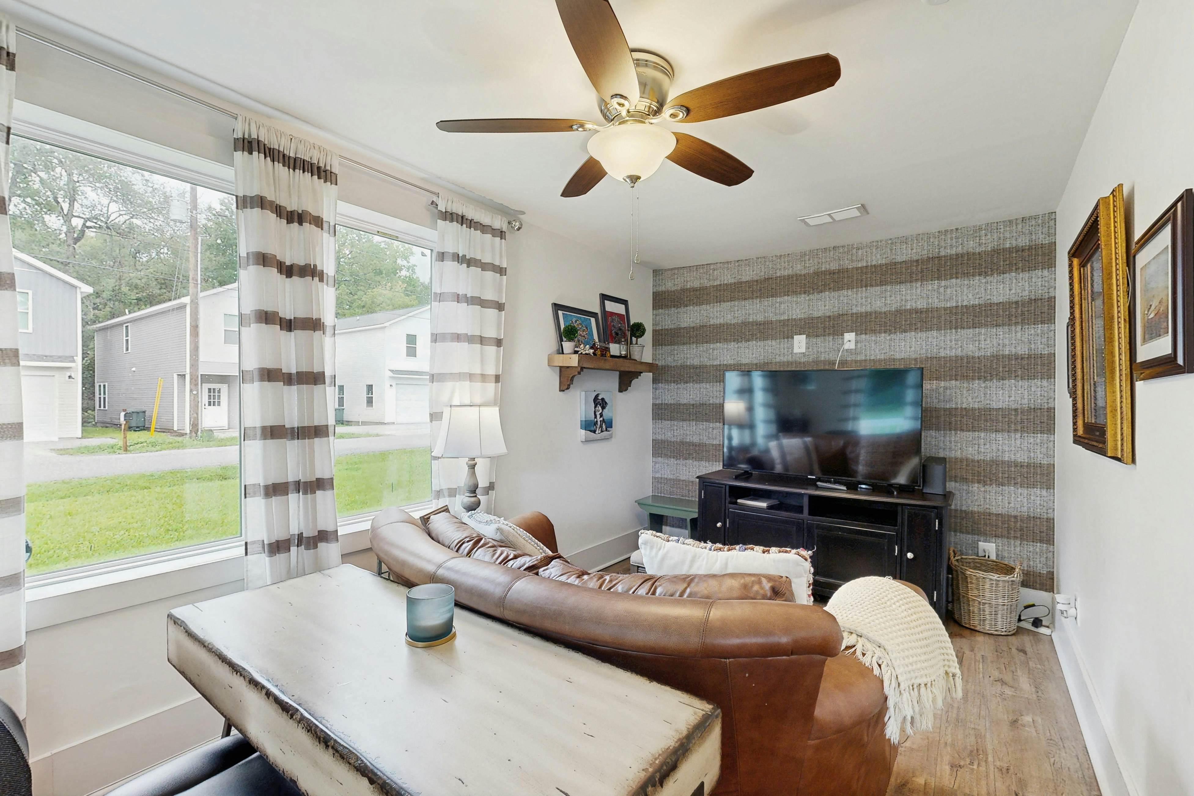 Breezy, renovated home with fenced yard, front porch & lovely living spaces