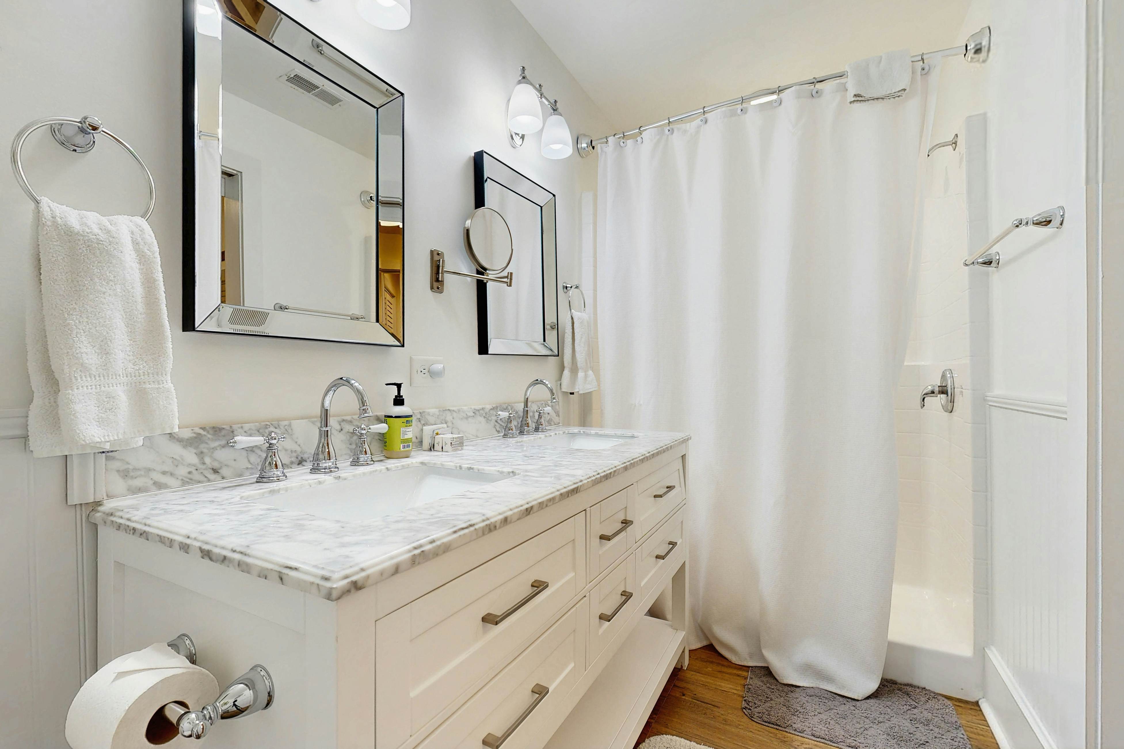 Breezy, renovated home with fenced yard, front porch & lovely living spaces