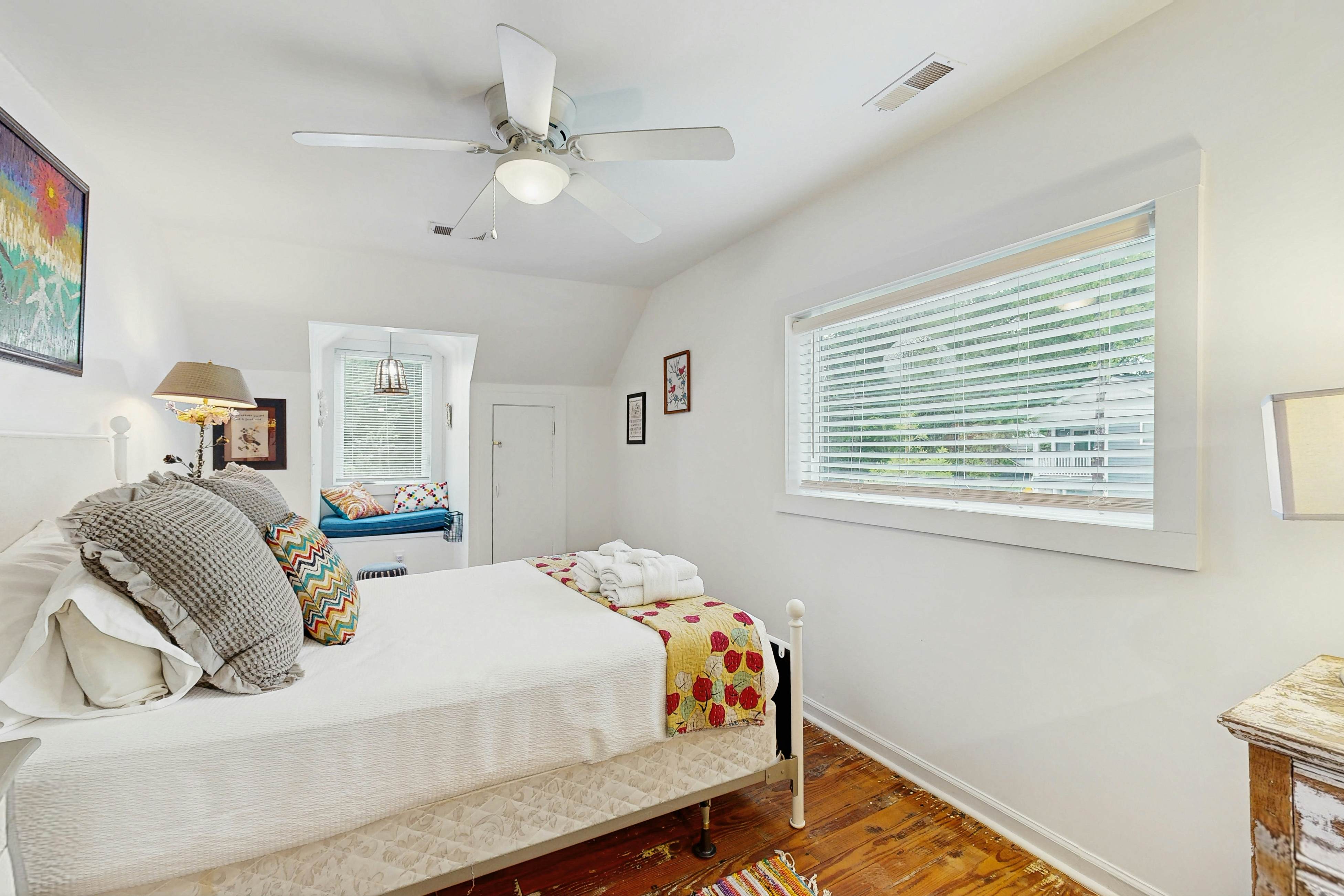 Breezy, renovated home with fenced yard, front porch & lovely living spaces