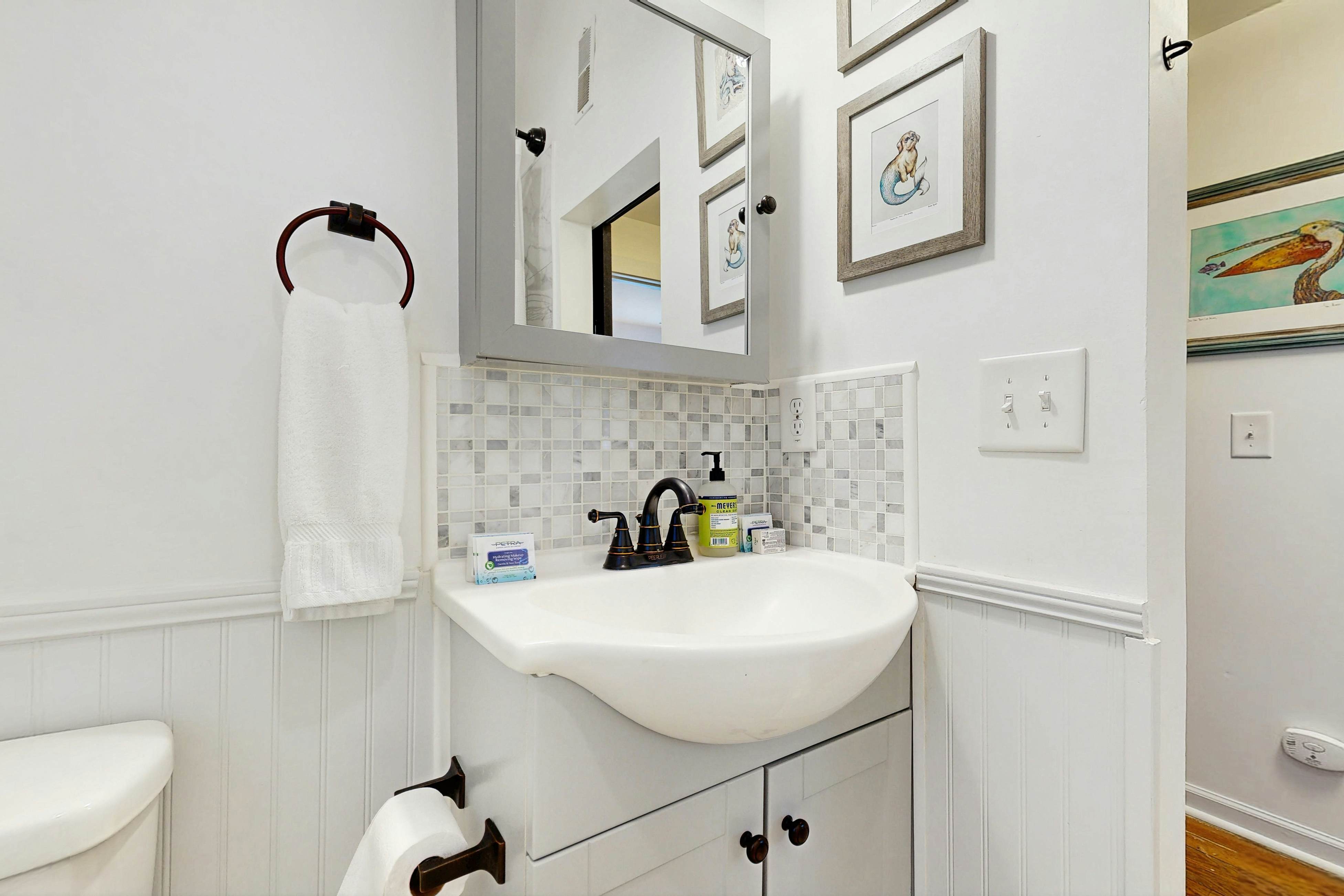 Breezy, renovated home with fenced yard, front porch & lovely living spaces