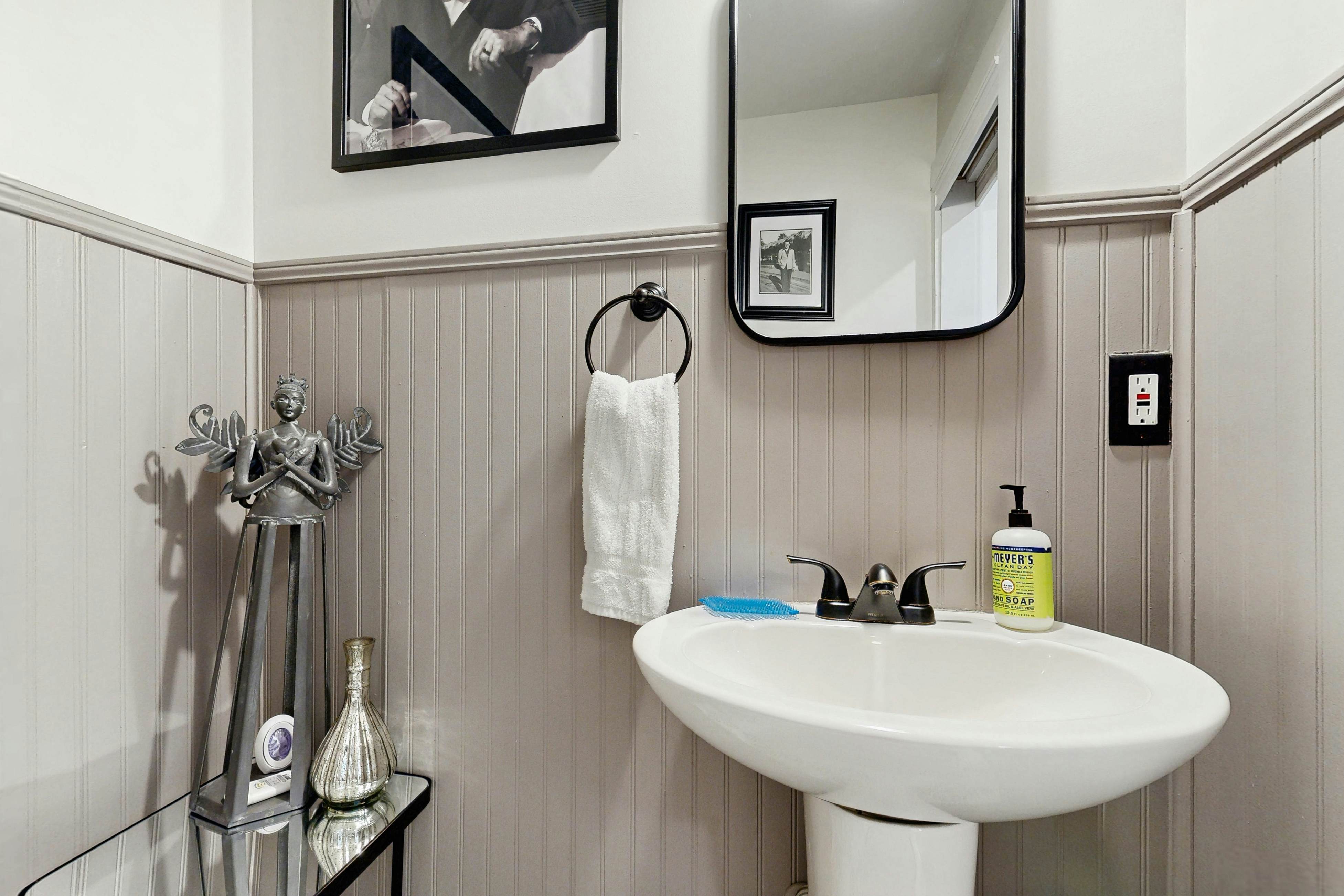 Breezy, renovated home with fenced yard, front porch & lovely living spaces