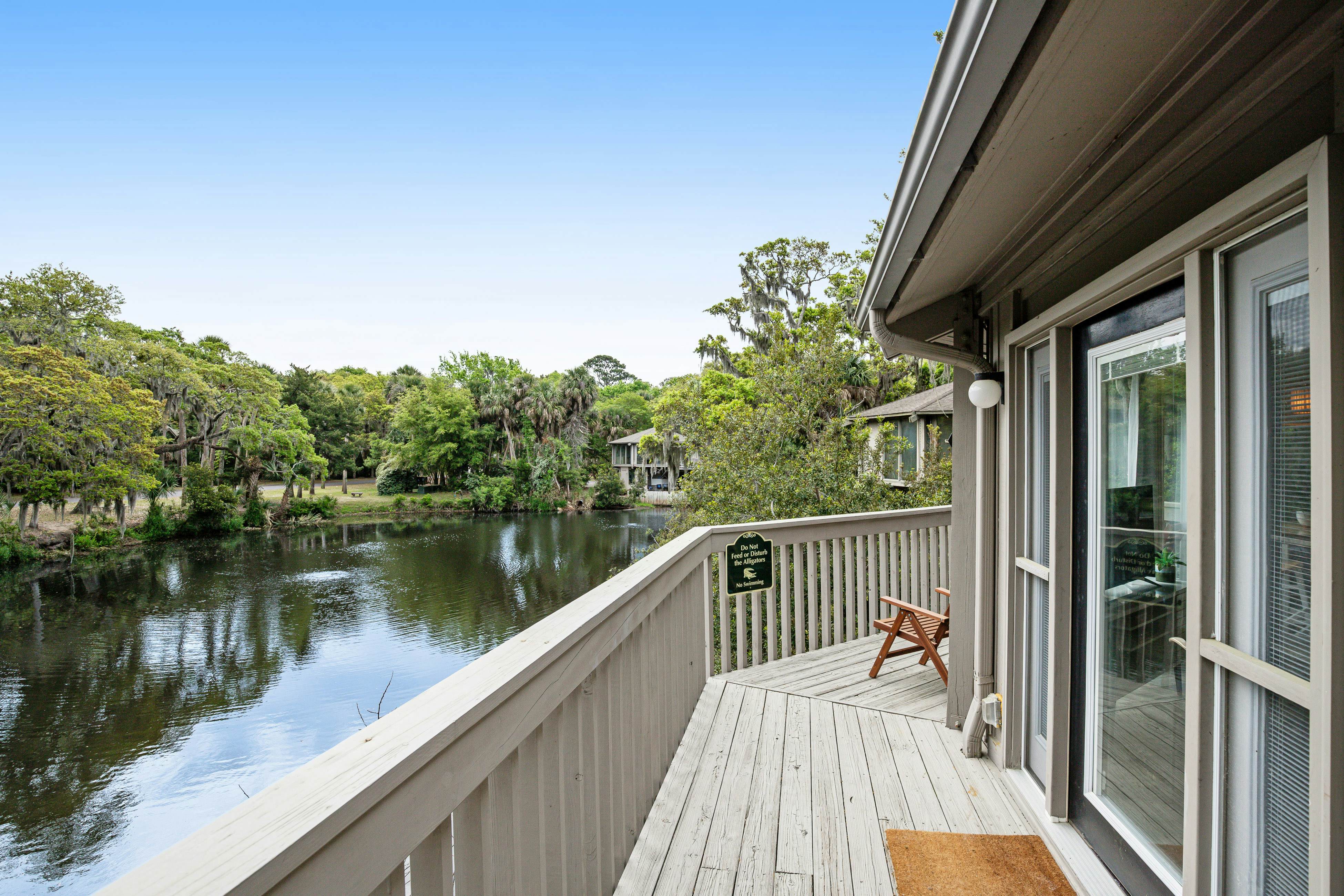 Lakefront home with lagoon view, deck & AC - close to beach, golf, & pools