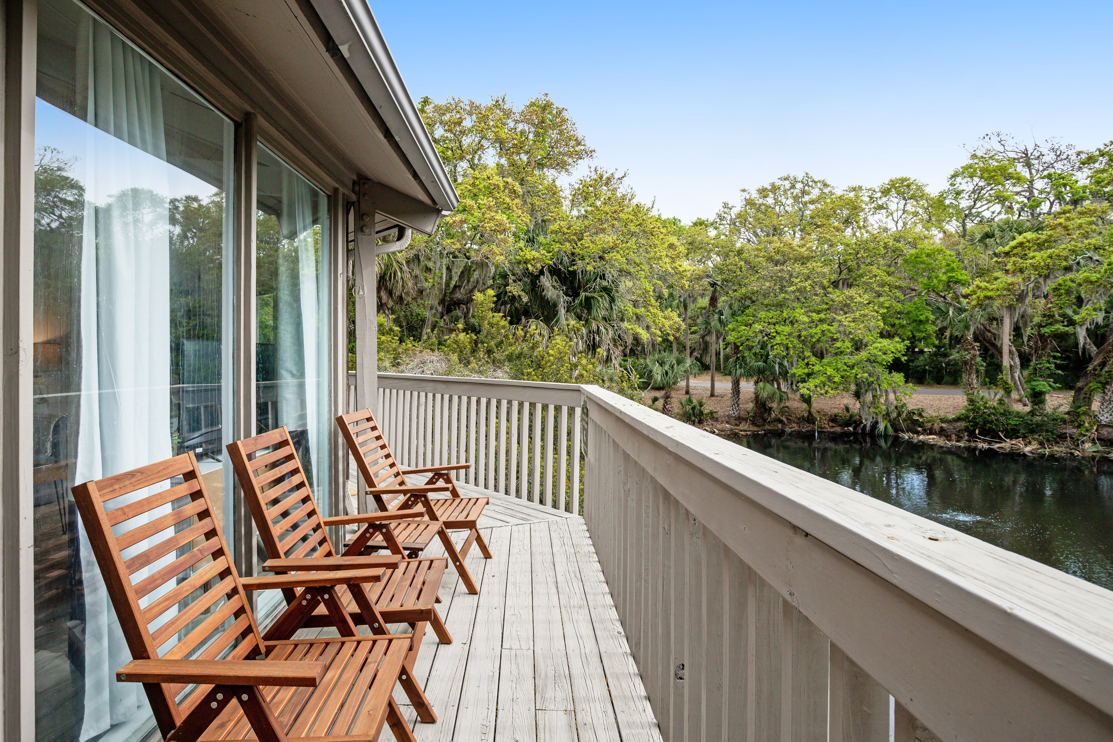 Lakefront home with lagoon view, deck & AC - close to beach, golf, & pools