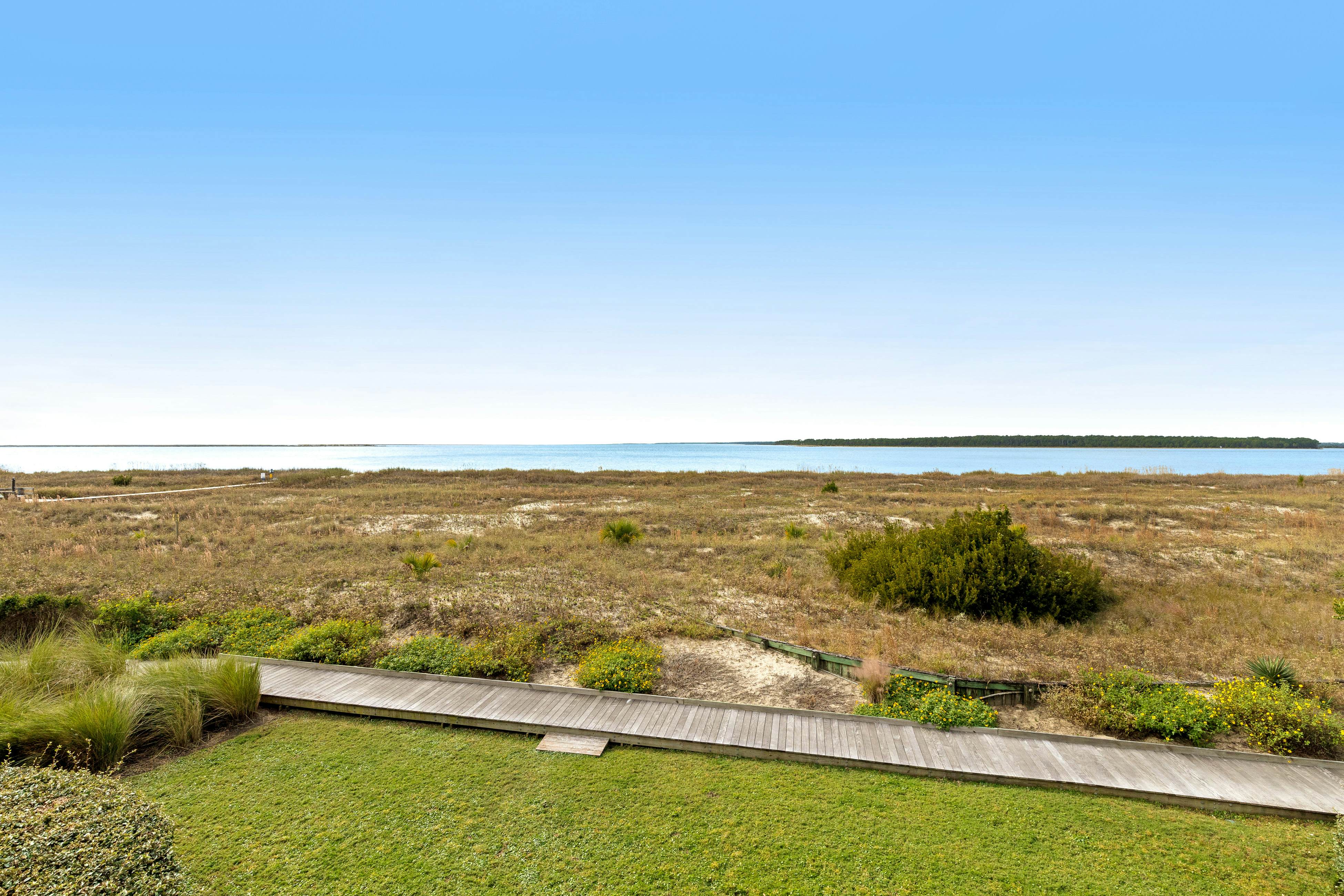 2nd floor villa with water views, lovely balcony & w/d - walk to Beach Club