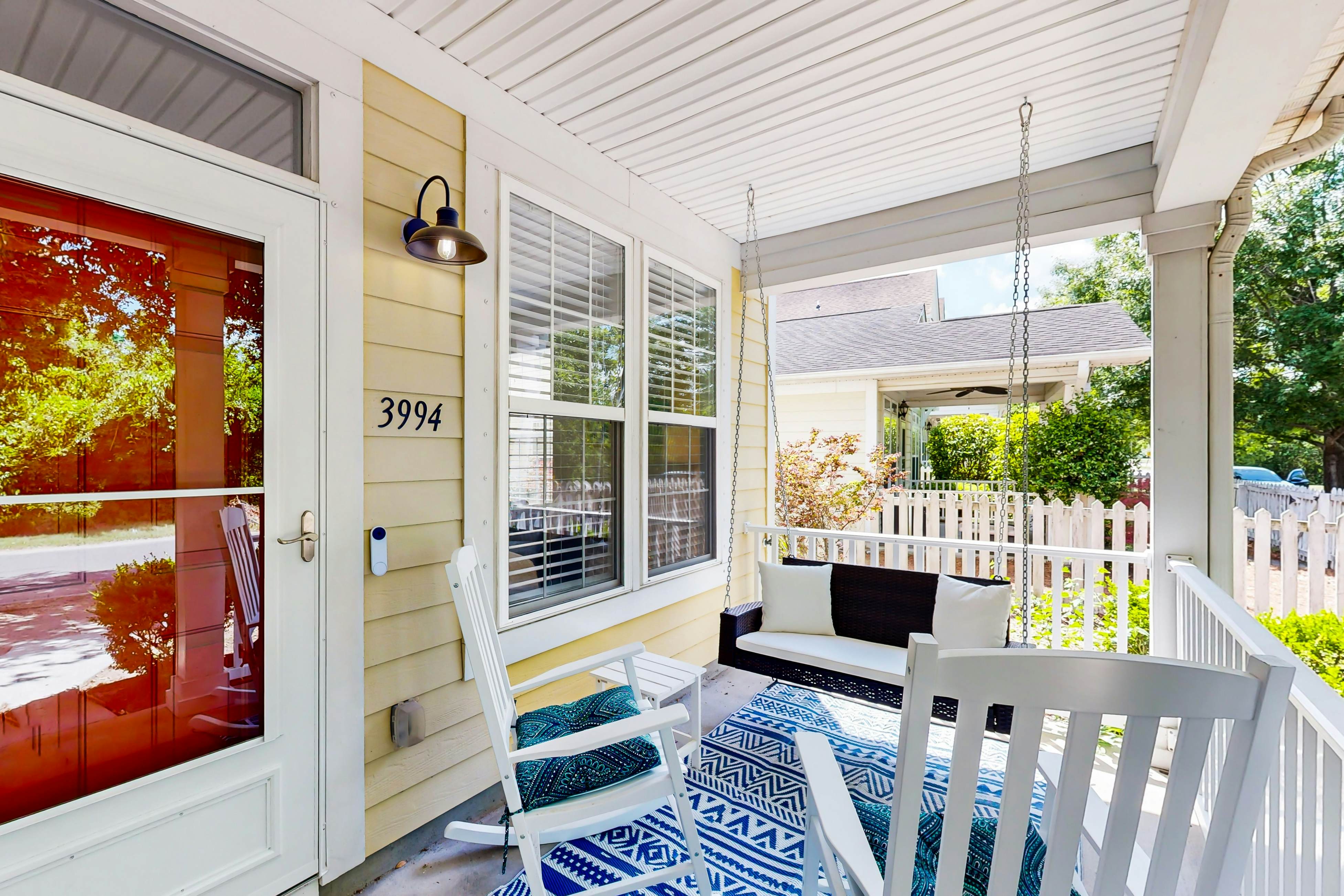 Quintessential townhome with front porch & location near dining & airport