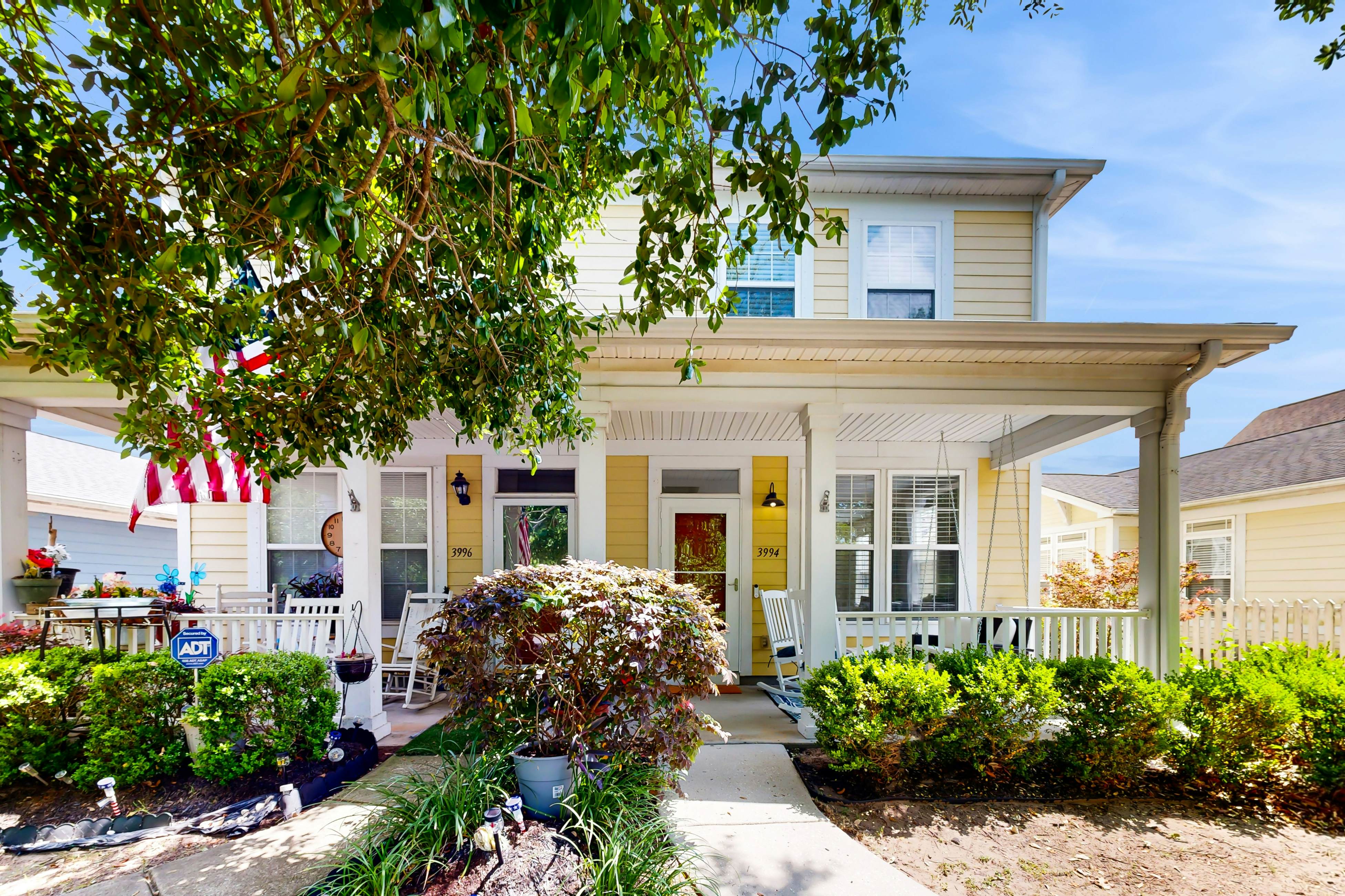 Quintessential townhome with front porch & location near dining & airport