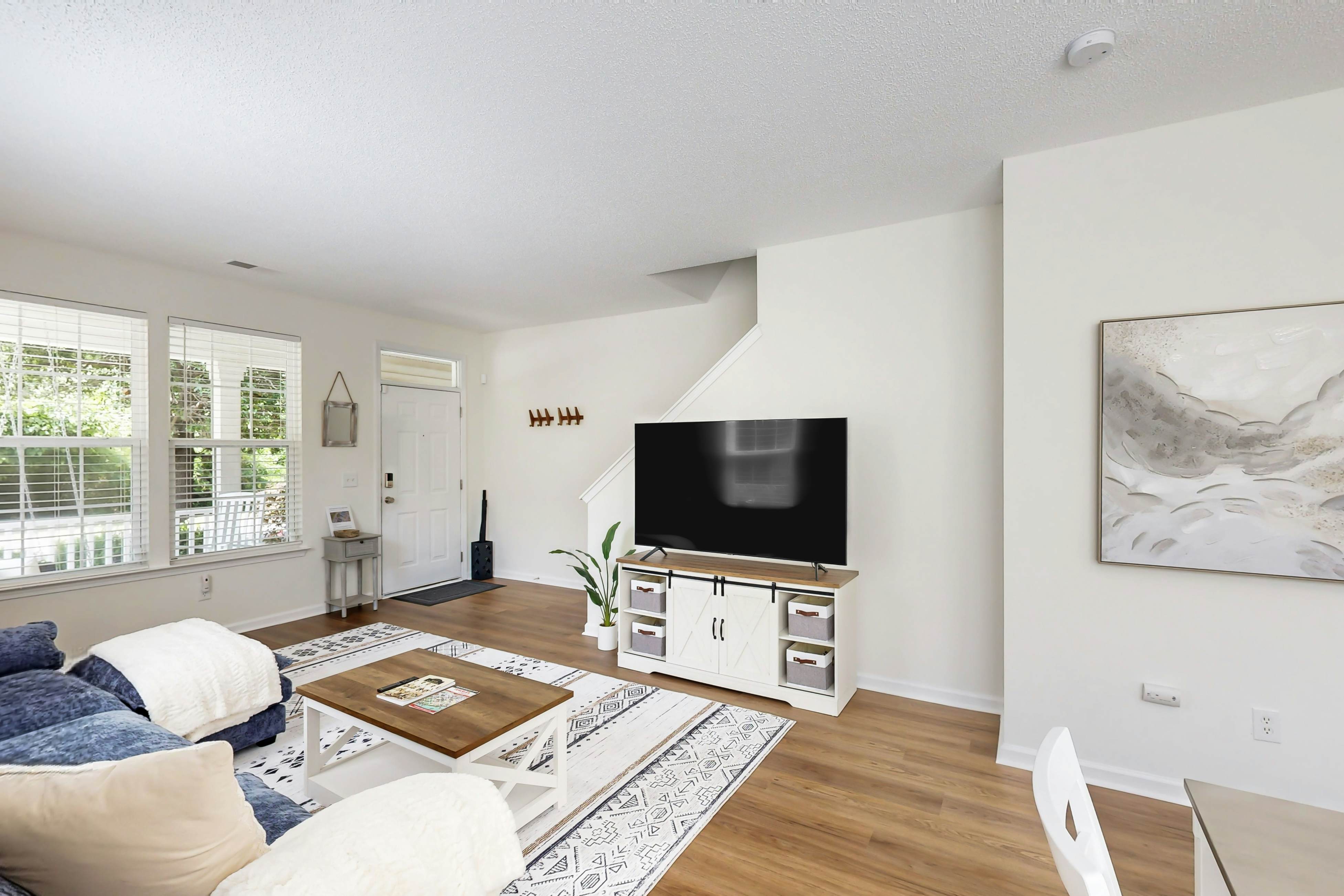 Quintessential townhome with front porch & location near dining & airport