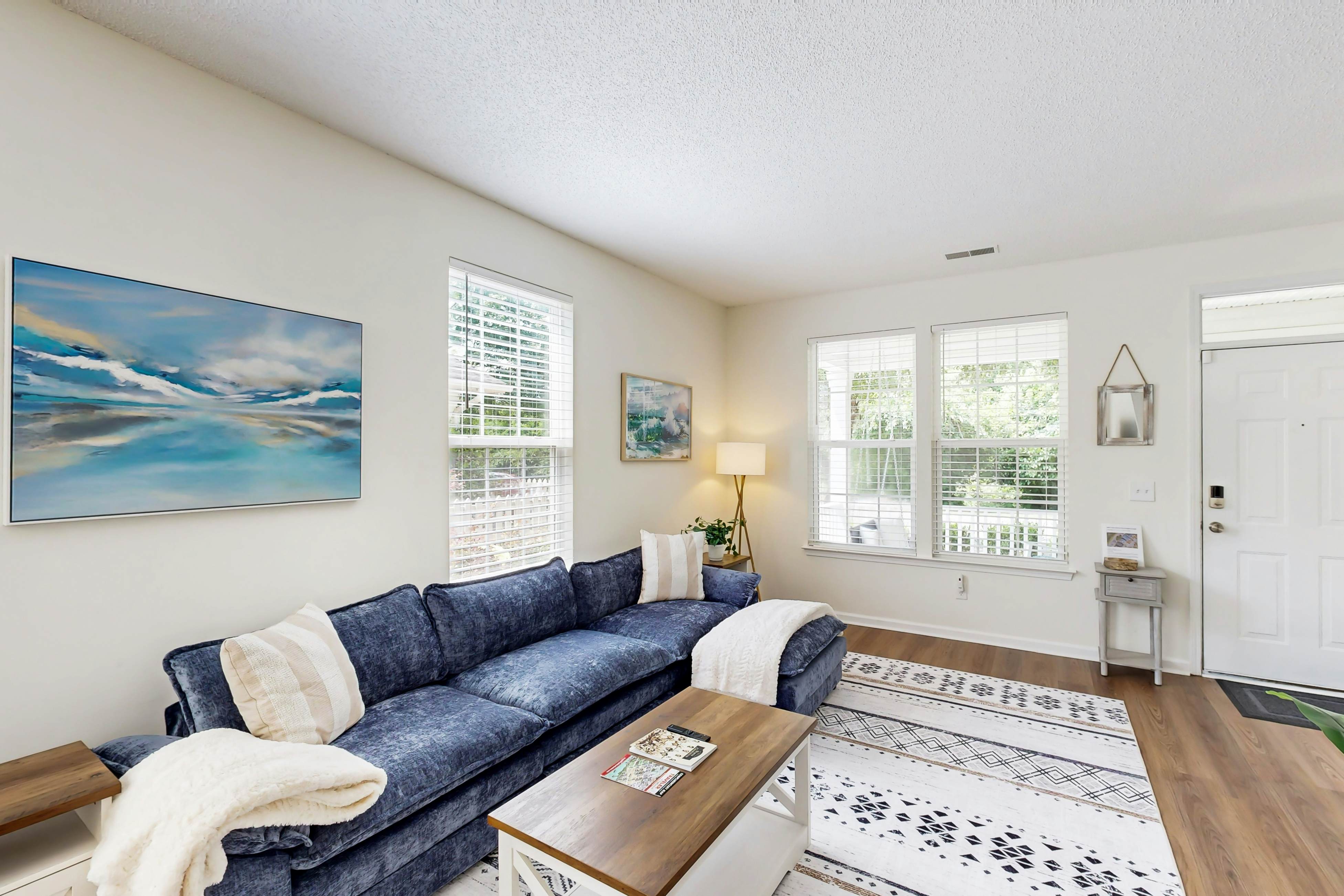 Quintessential townhome with front porch & location near dining & airport