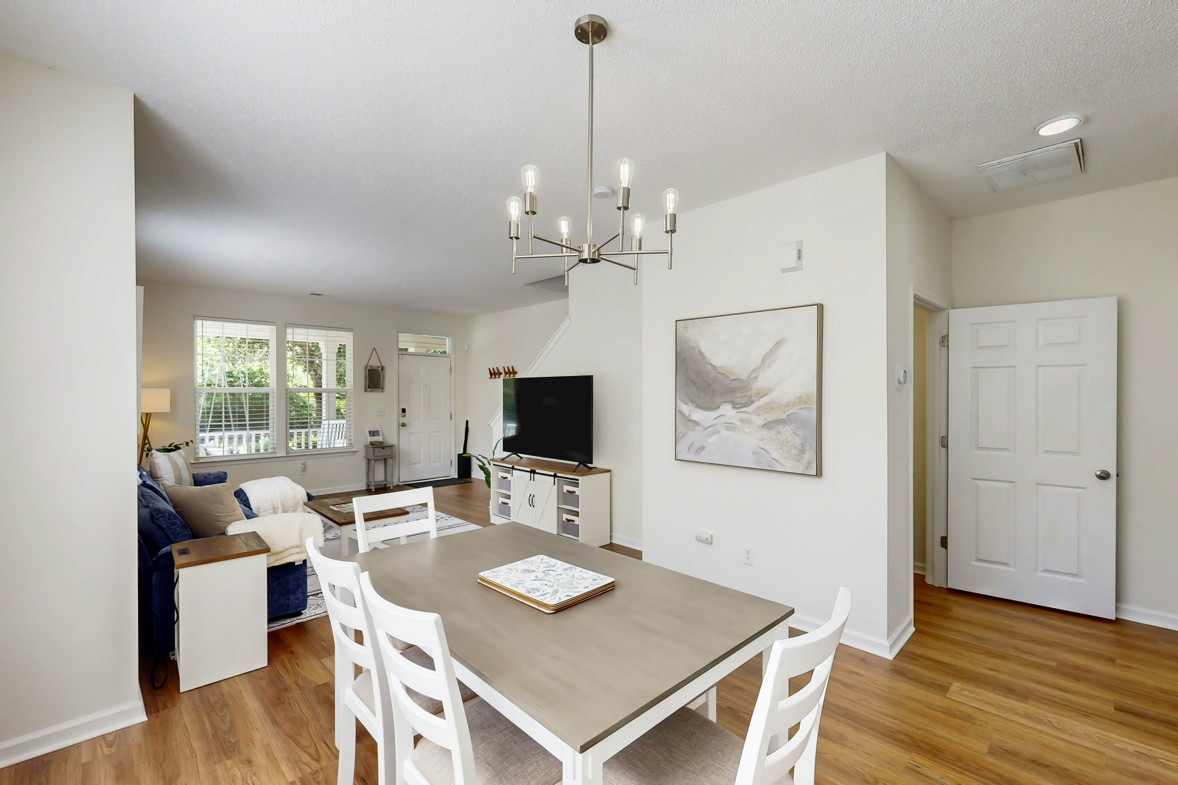 Quintessential townhome with front porch & location near dining & airport