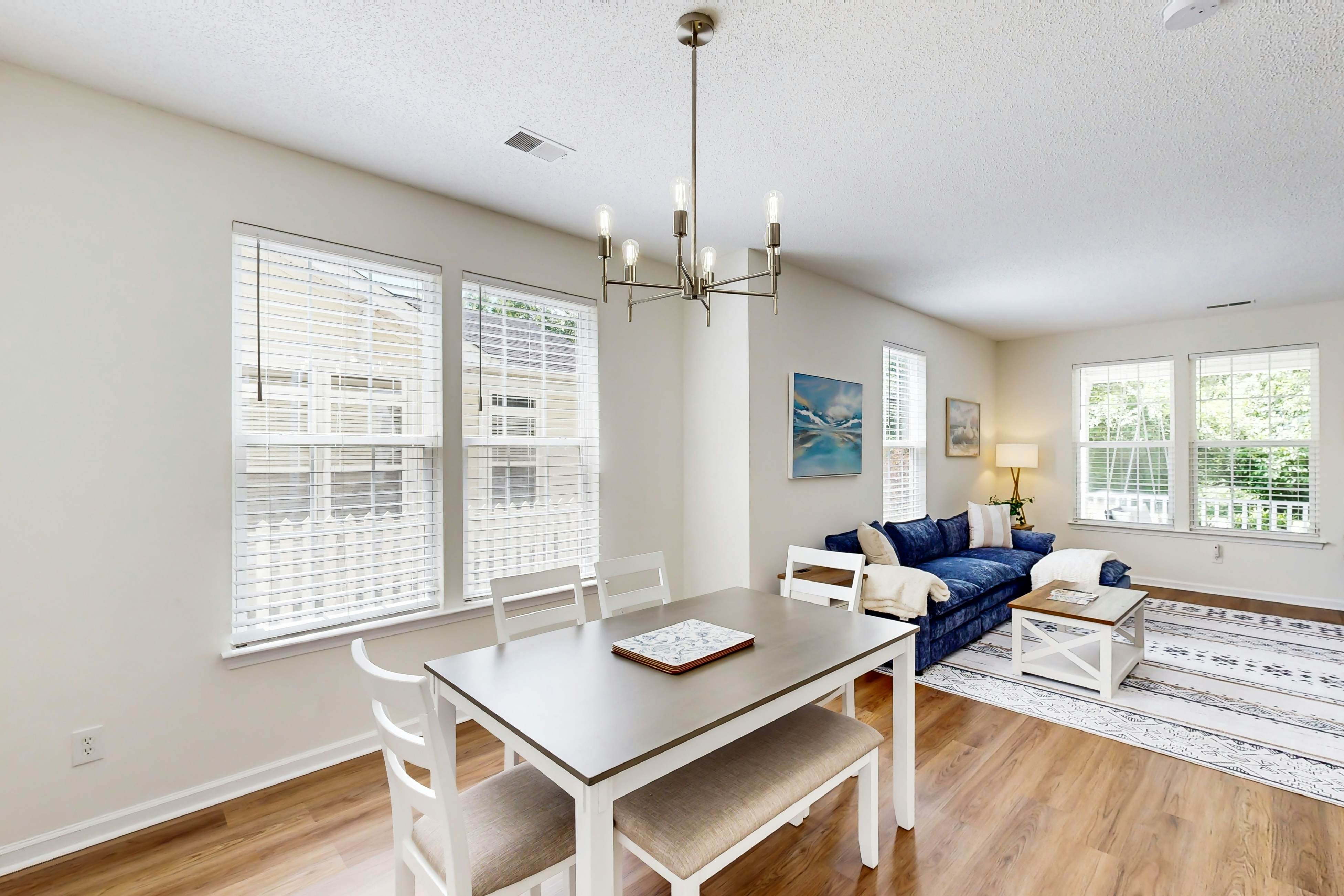 Quintessential townhome with front porch & location near dining & airport