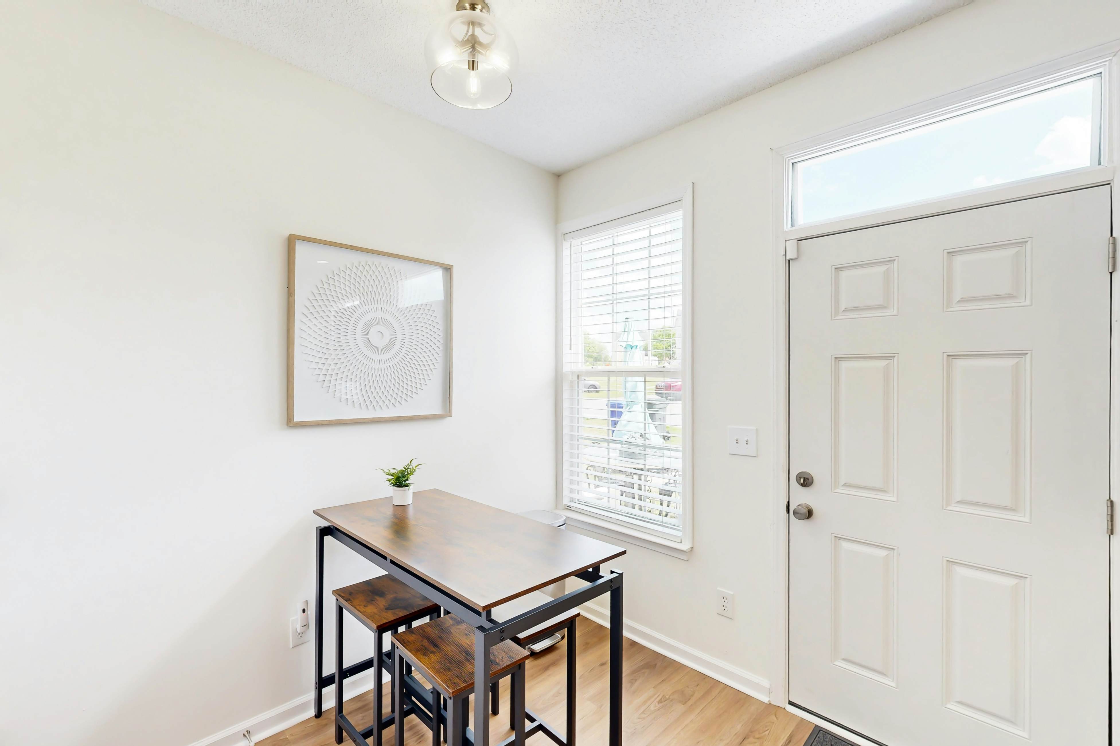 Quintessential townhome with front porch & location near dining & airport