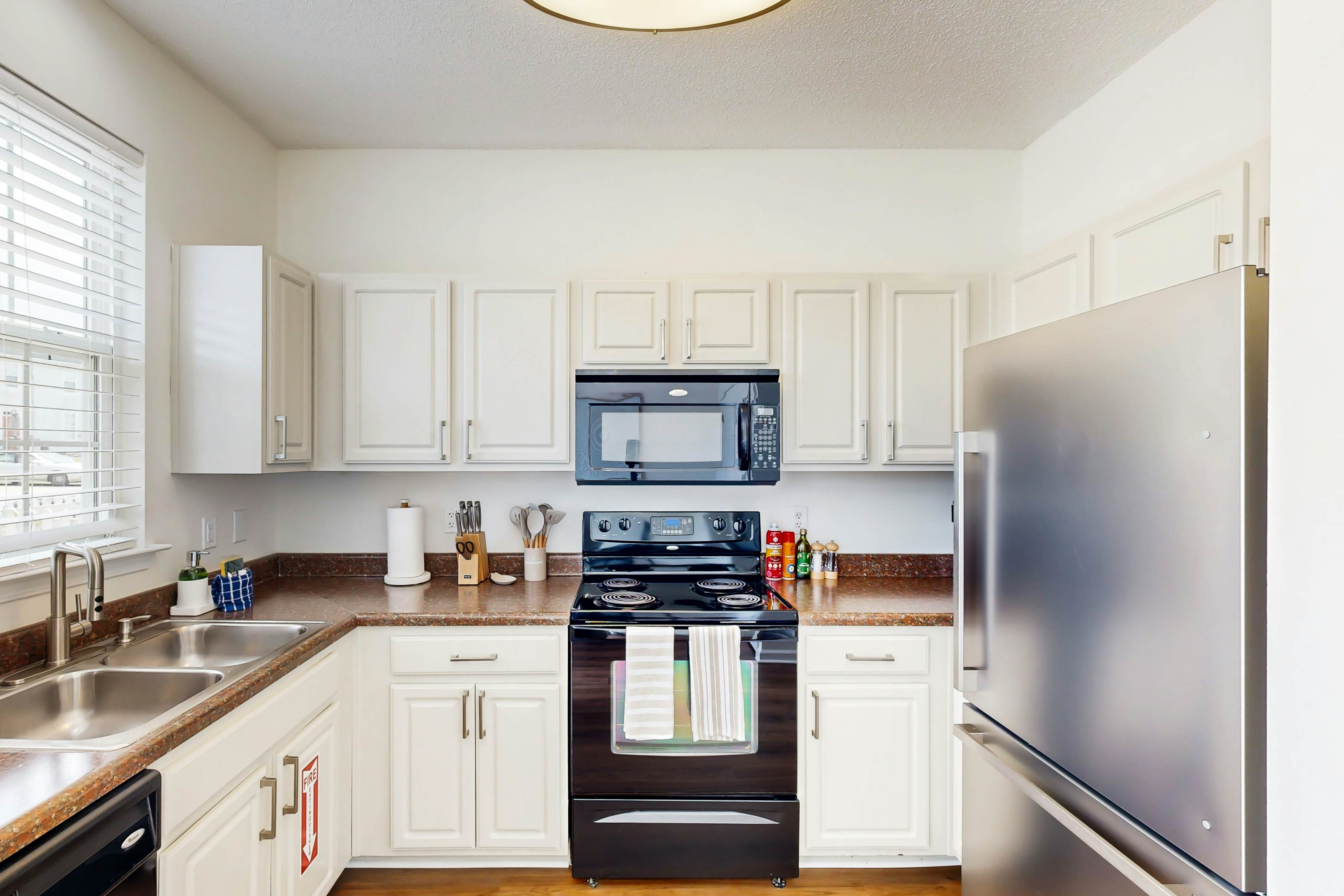 Quintessential townhome with front porch & location near dining & airport