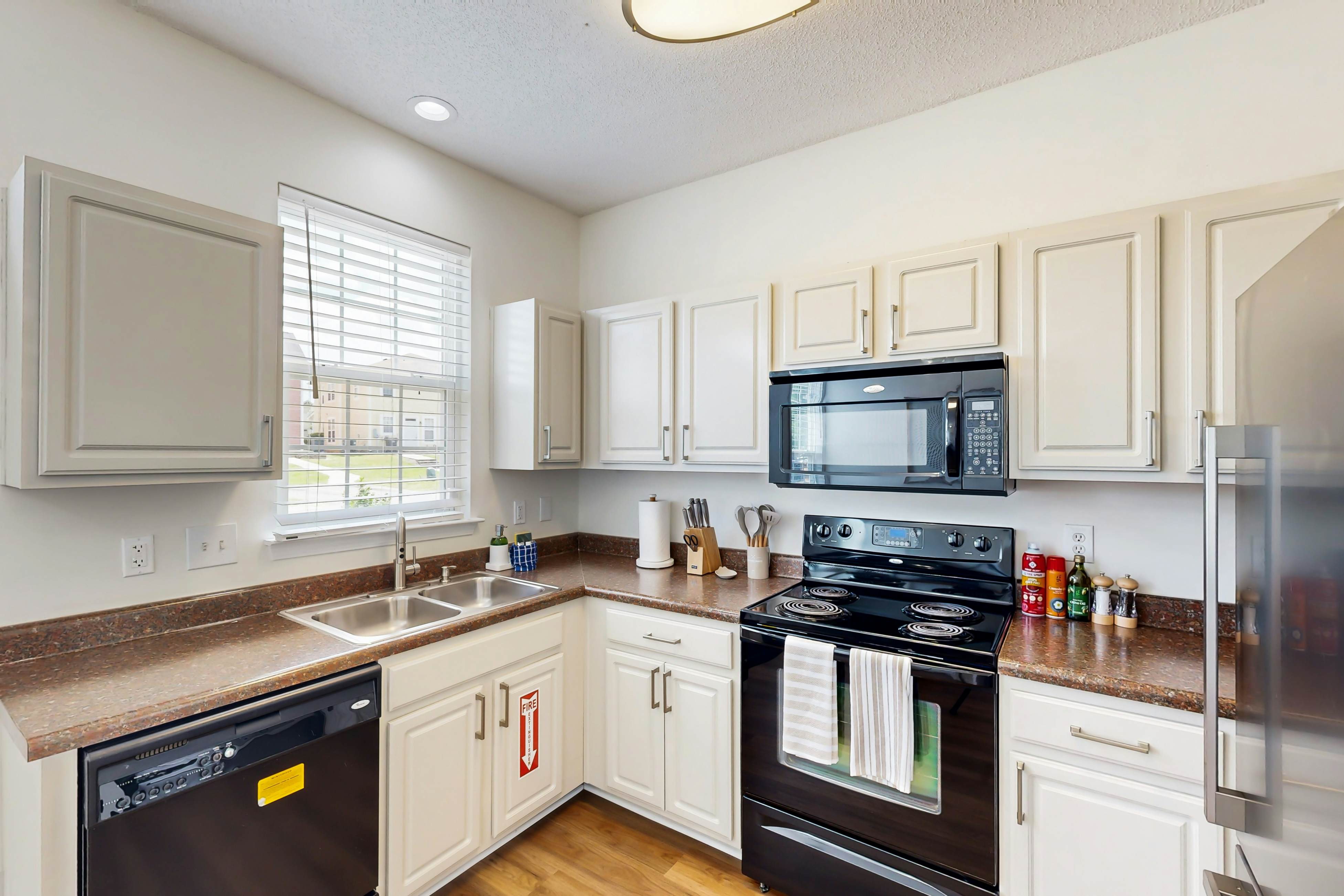 Quintessential townhome with front porch & location near dining & airport