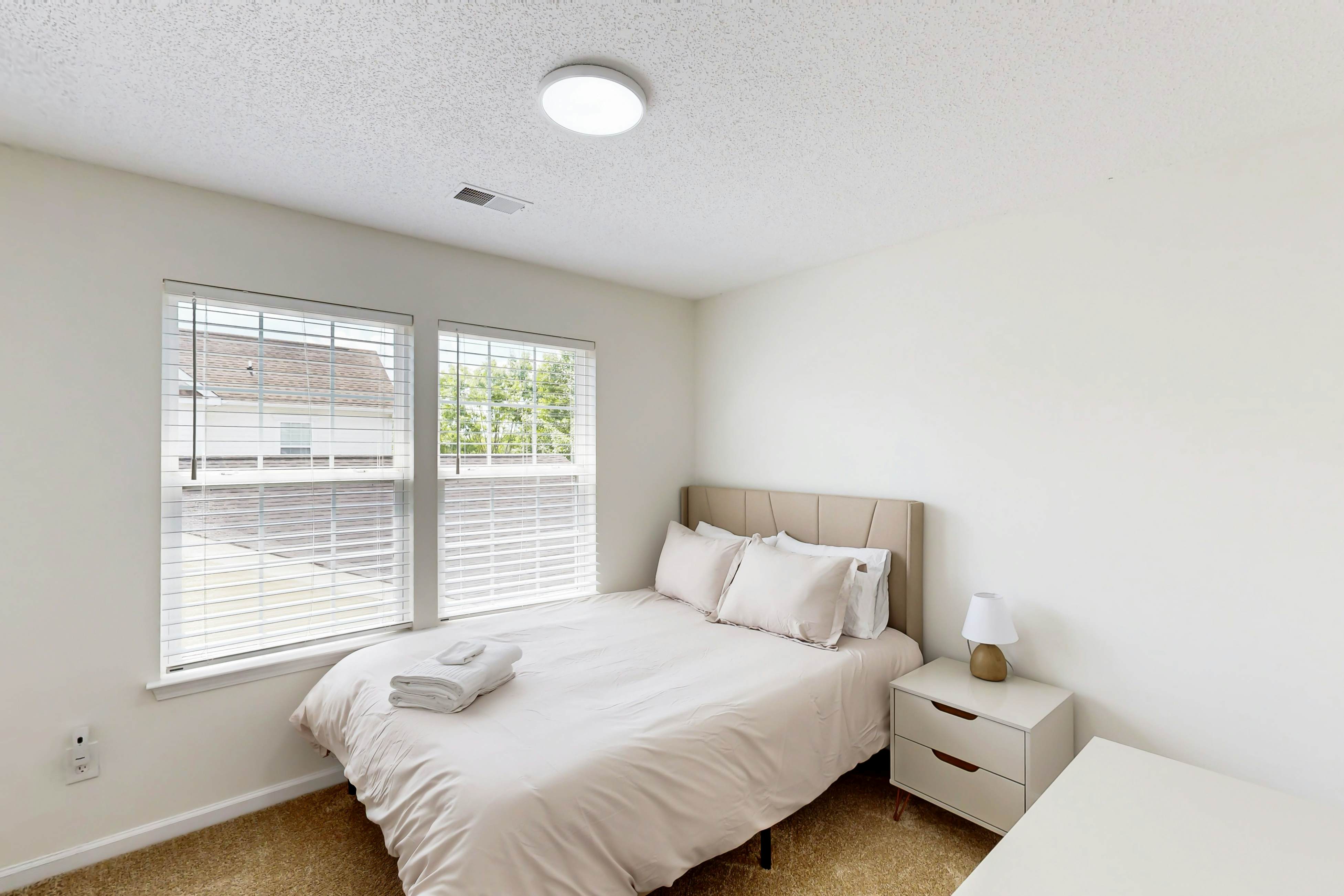 Quintessential townhome with front porch & location near dining & airport