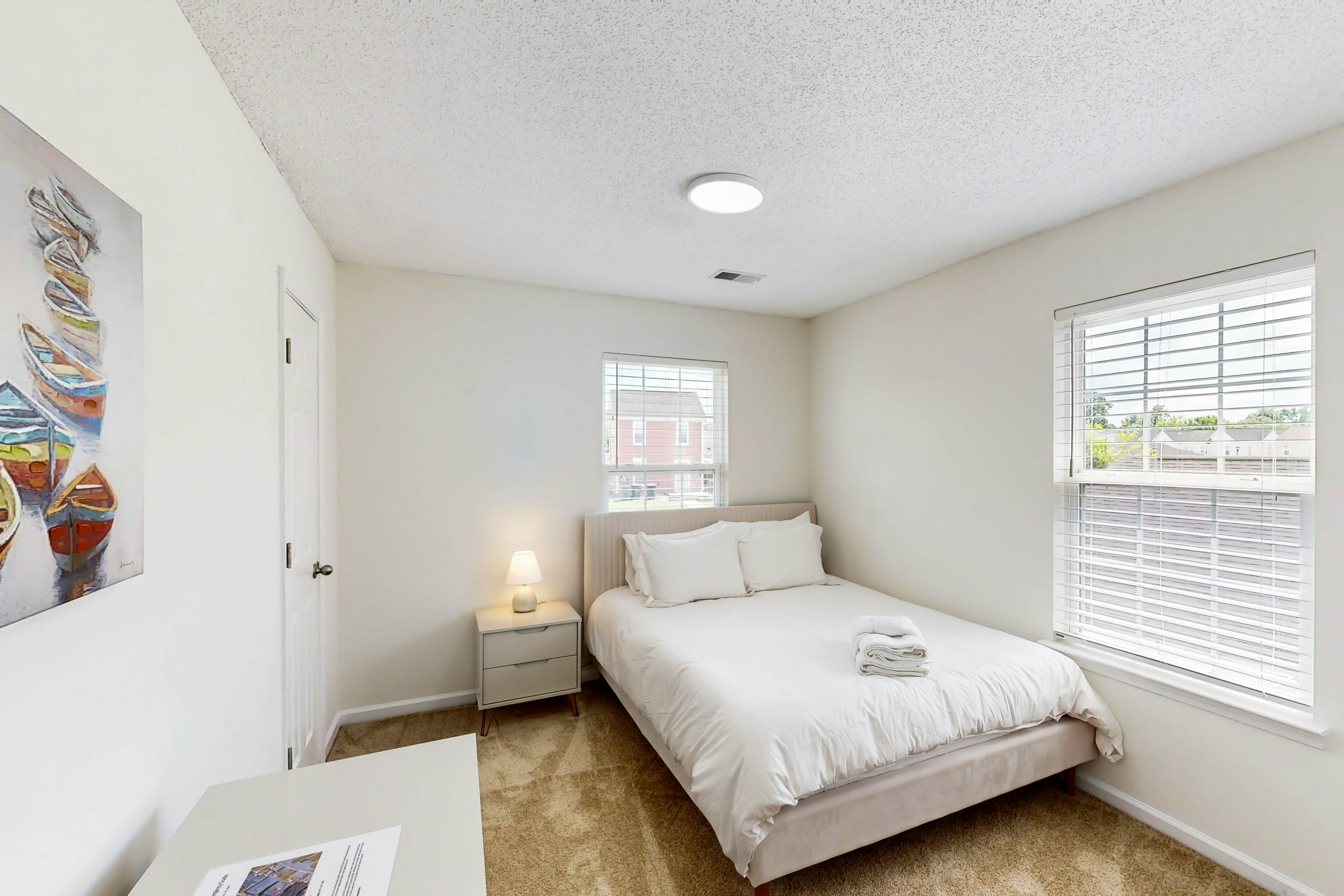 Quintessential townhome with front porch & location near dining & airport