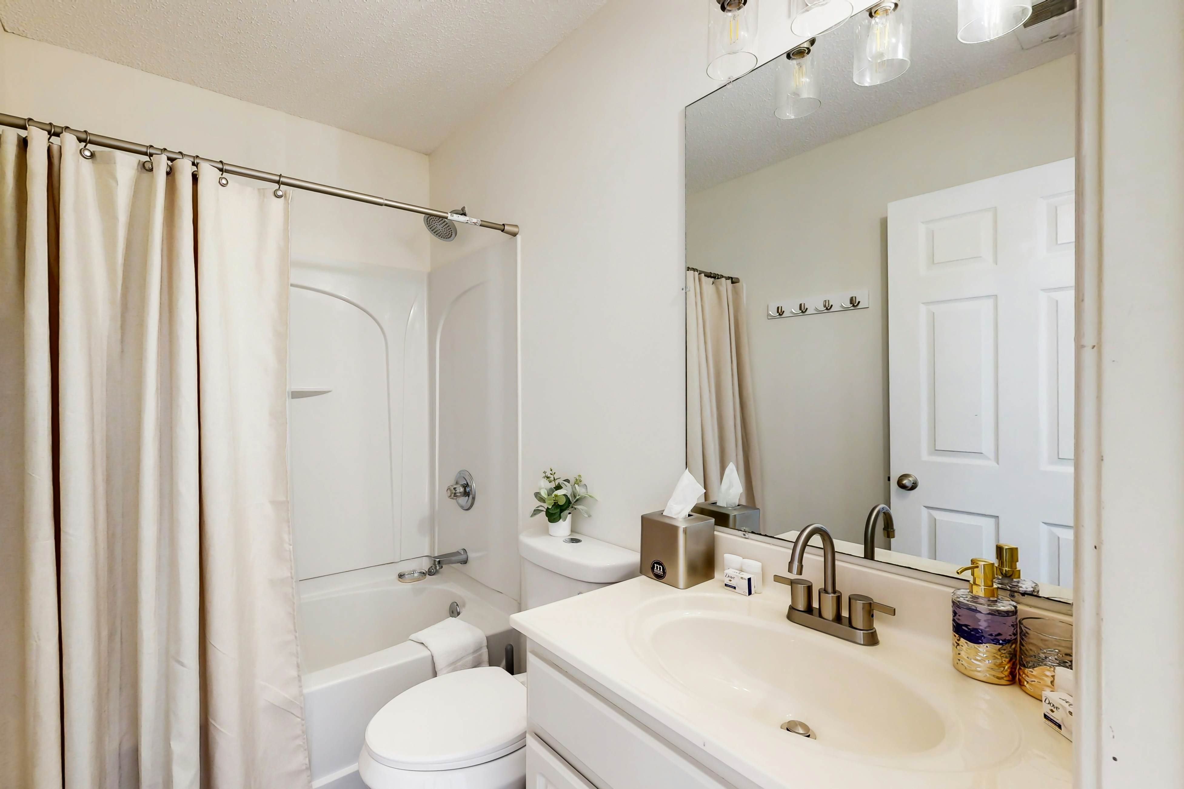 Quintessential townhome with front porch & location near dining & airport