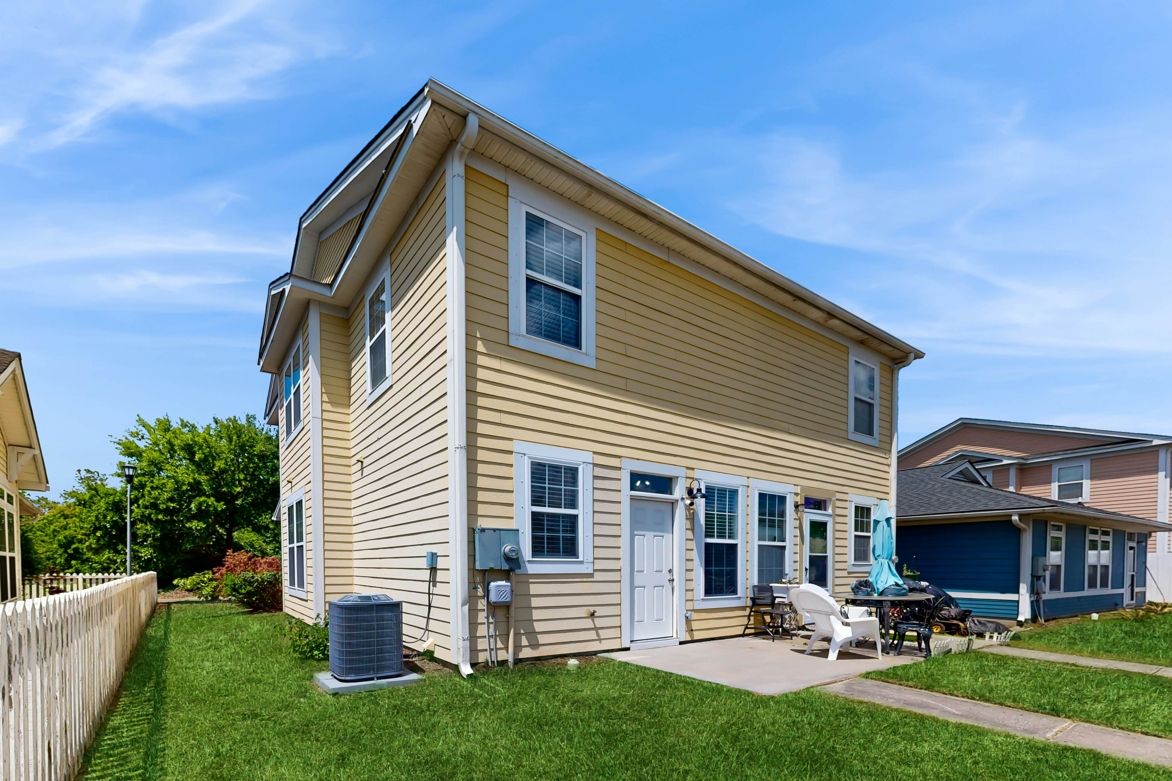 Quintessential townhome with front porch & location near dining & airport