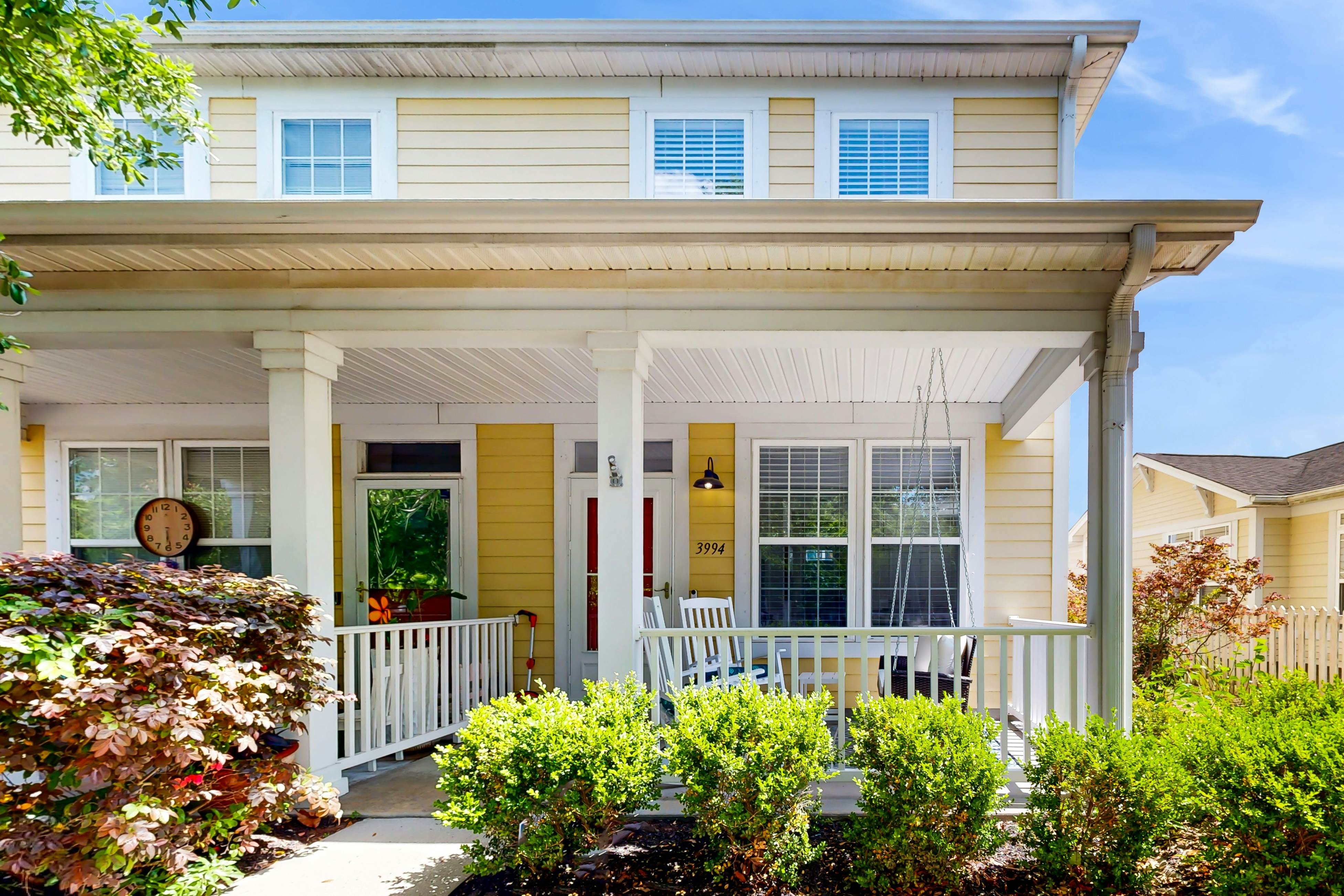 Quintessential townhome with front porch & location near dining & airport