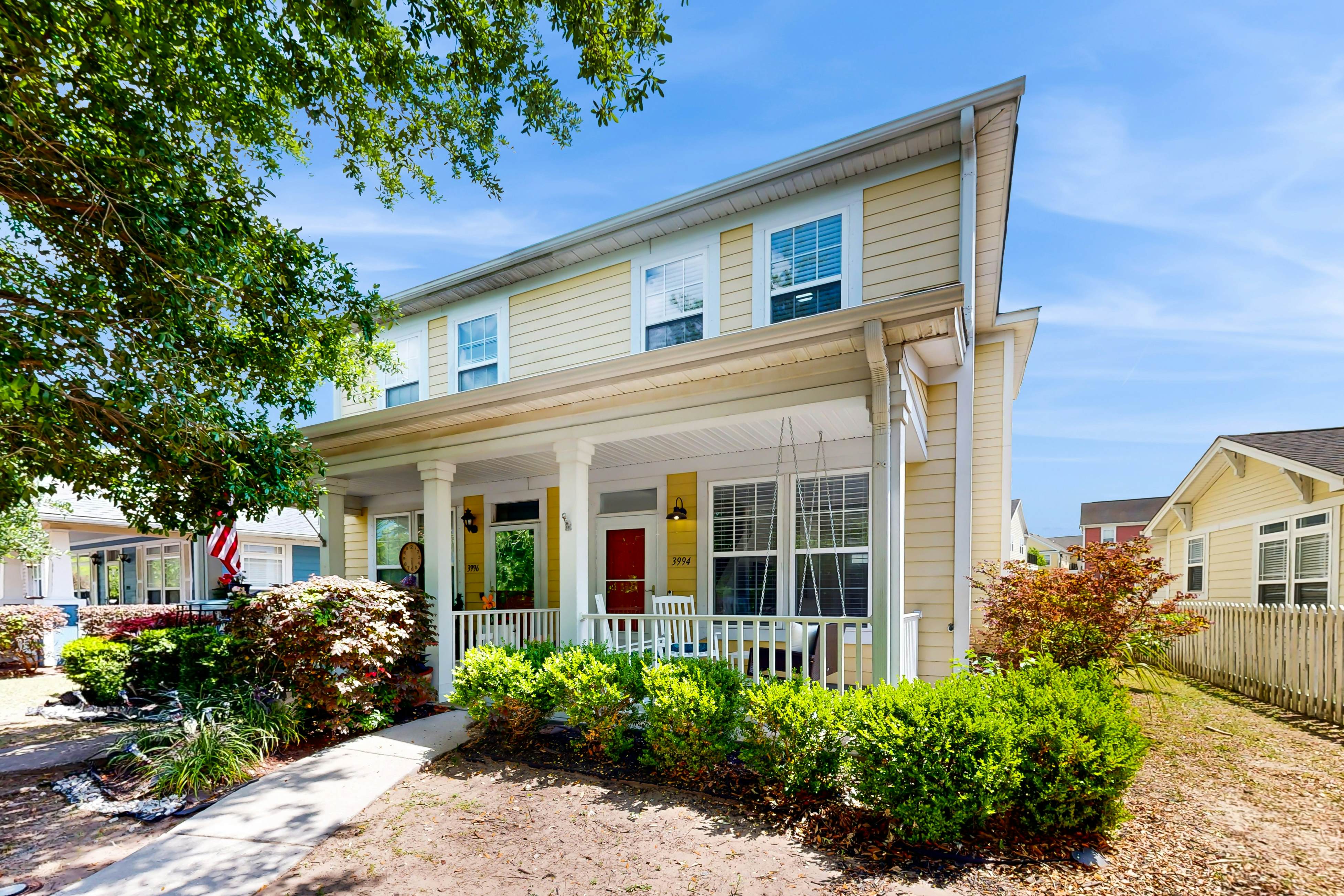 Quintessential townhome with front porch & location near dining & airport