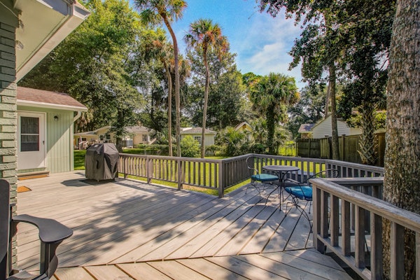 Refined coastal home surrounded by palms with large deck & athletic court access