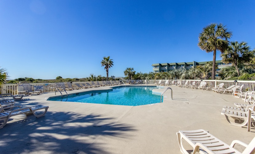 Oceanfront condo with water views, pool, balcony, & easy beach access