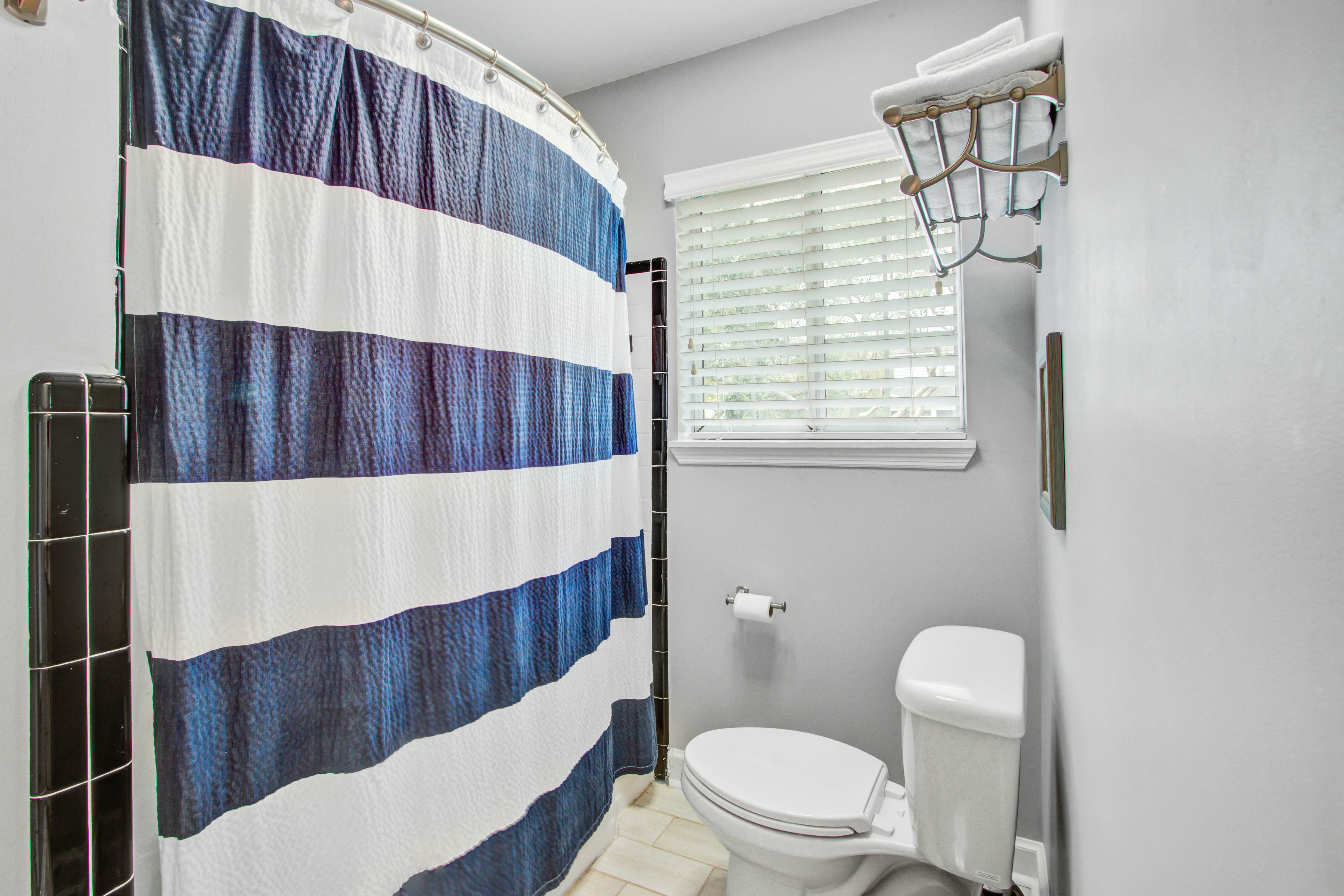 Convenient dog-friendly retreat steps from the beach with grill & screened porch