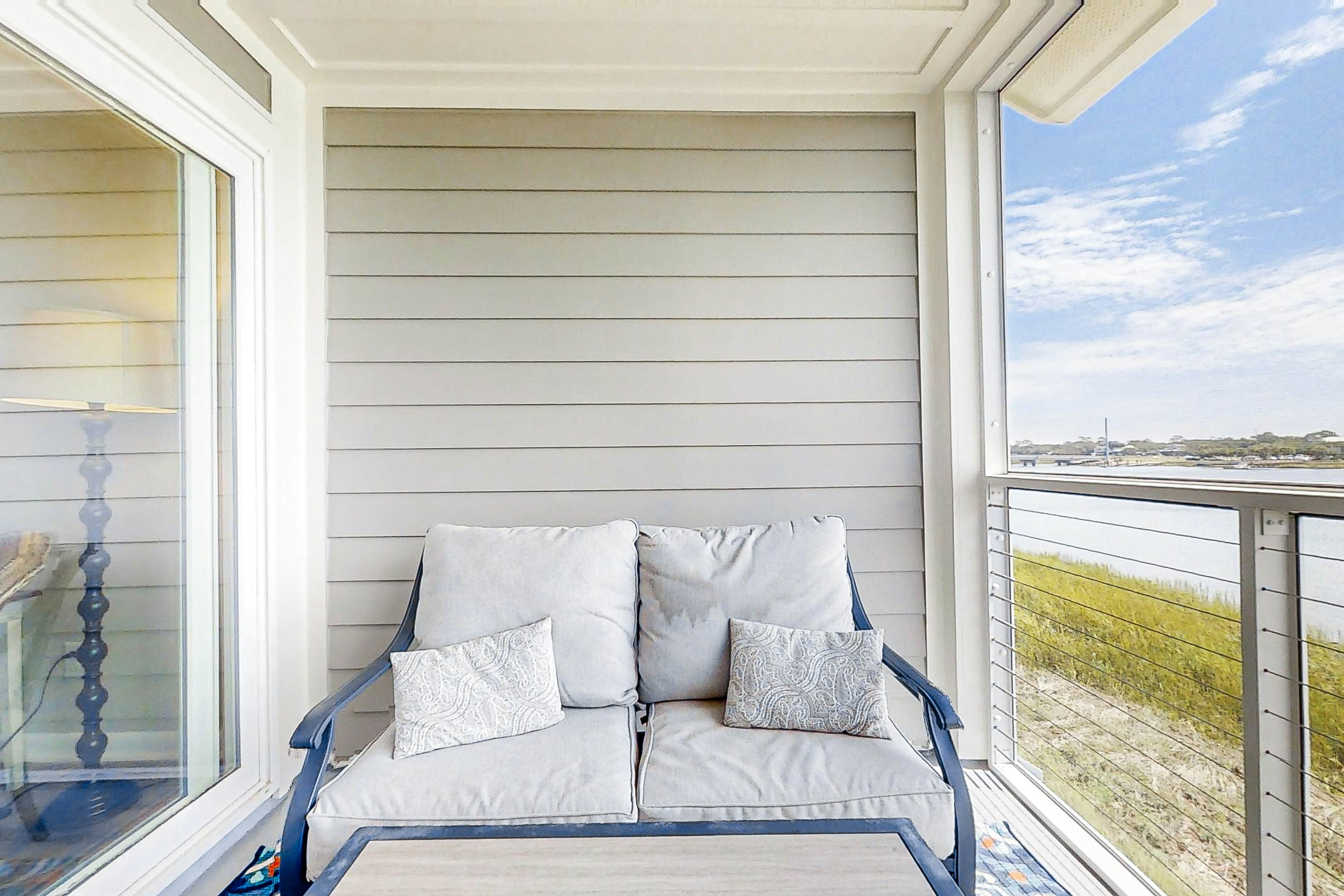 Newly renovated two-story waterfront condo with screened porch, pool, & tennis