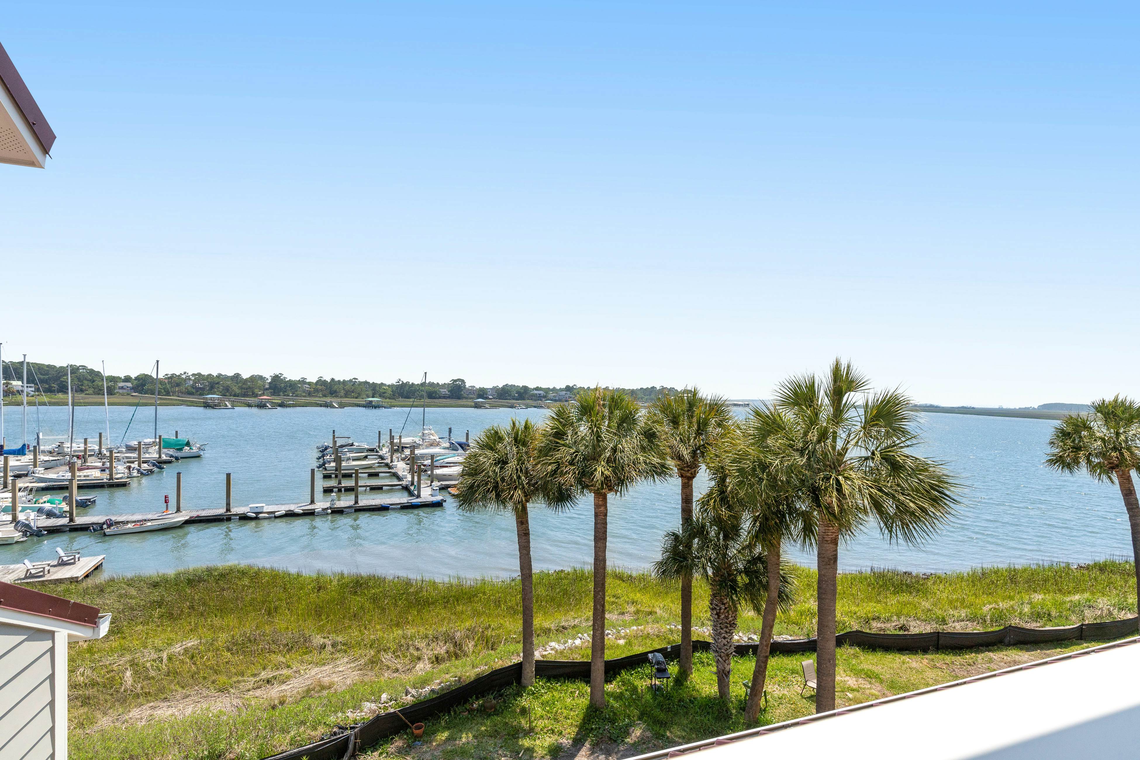 Second-floor villa w/ river views & community pool, tennis courts, and dock