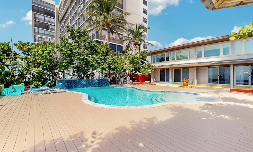 Beachfront condo with pool and island vibes