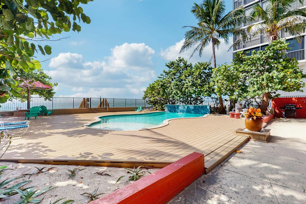 Beachfront condo with pool and island vibes