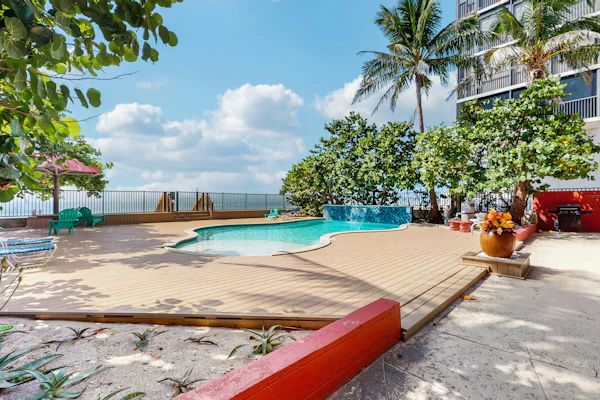 Beachfront condo with pool and island vibes