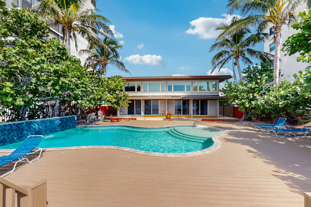 Beachfront condo with pool and island vibes