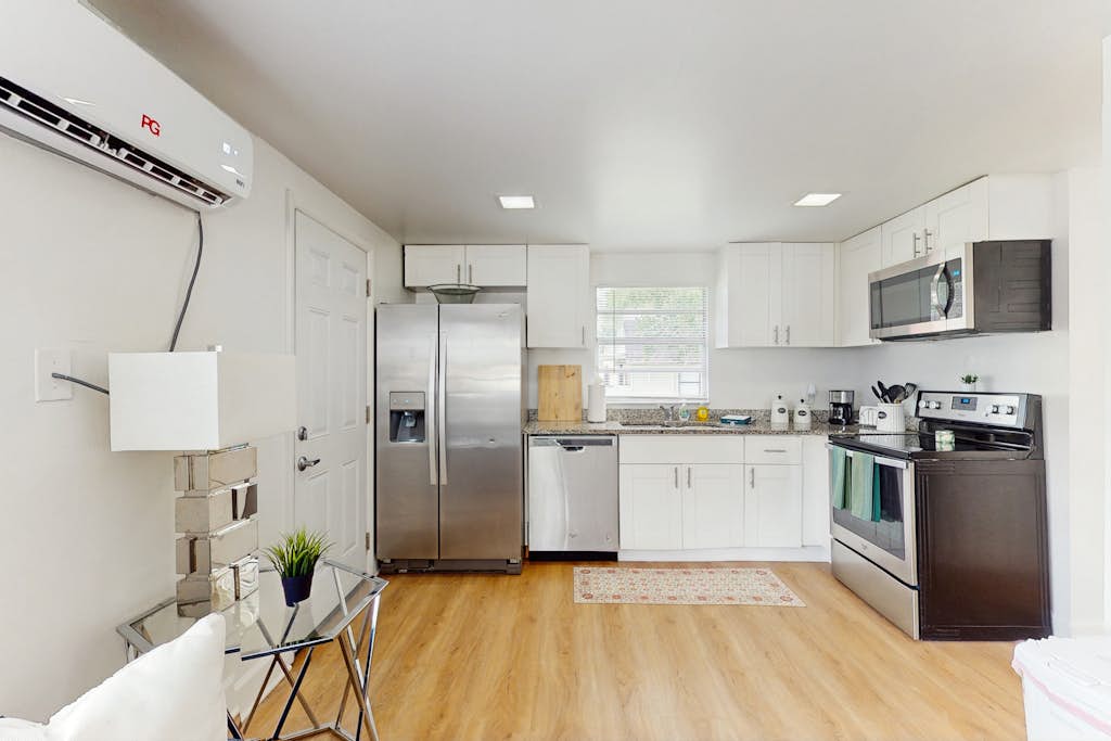 Centrally located comfortable duplex unit with AC kitchen with enclosed yard