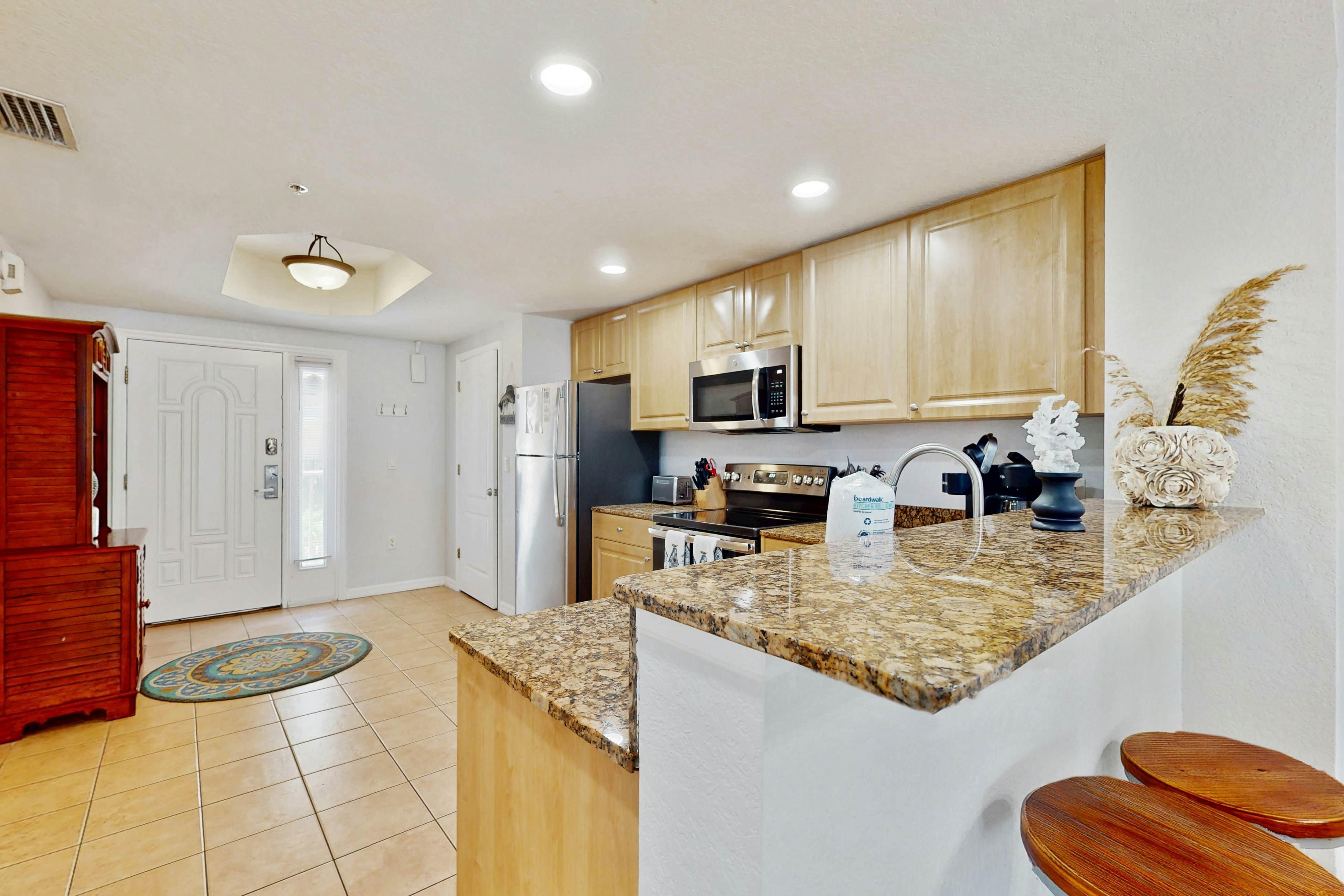 Second-floor condo with beach access, balcony, pool, hot tubs, and ping-pong