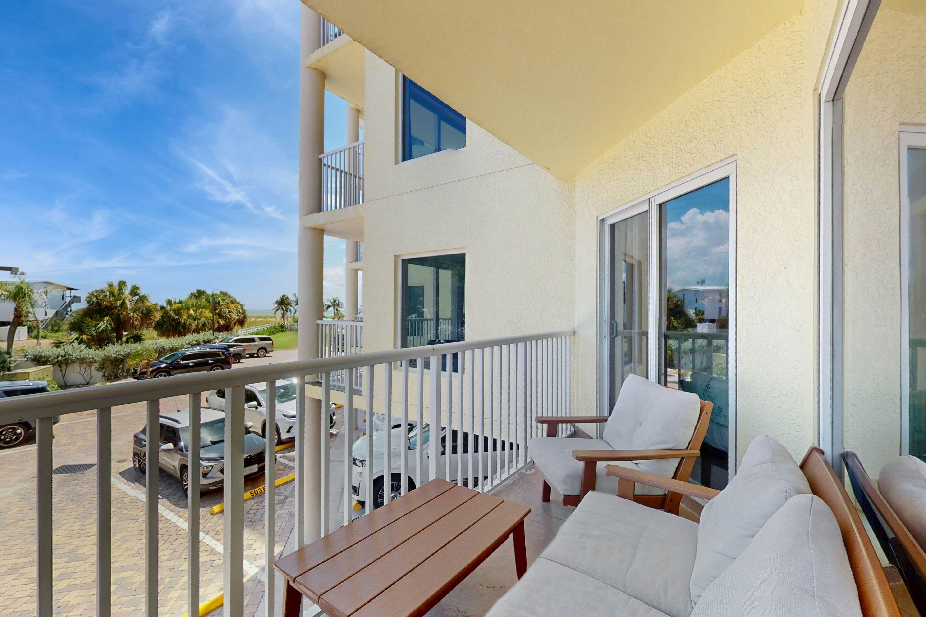 Second-floor condo with beach access, balcony, pool, hot tubs, and ping-pong